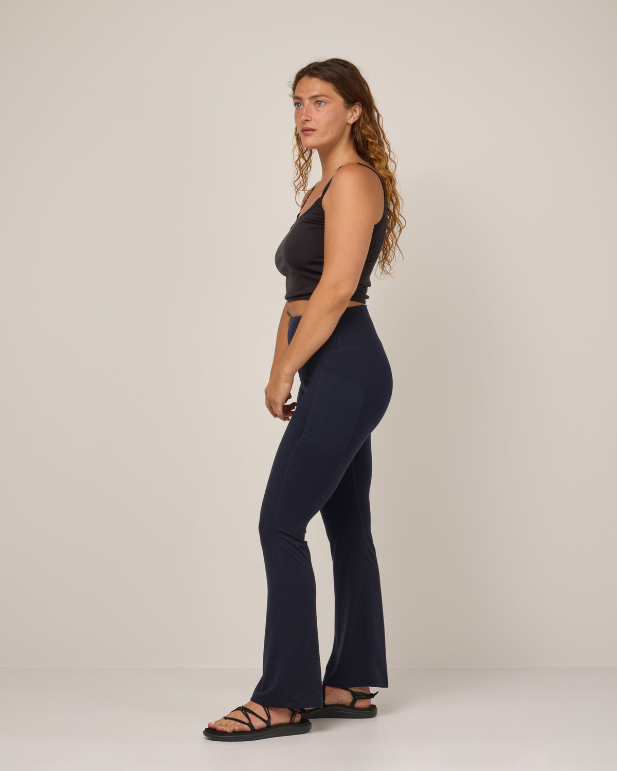 Model wearing Summit Straight Cut Pocket Legging in Navy. Summit Straight Cut Pocket Legging is a merino wool legging with pockets available in sizes XS-3X Regular, S-XXL Long.