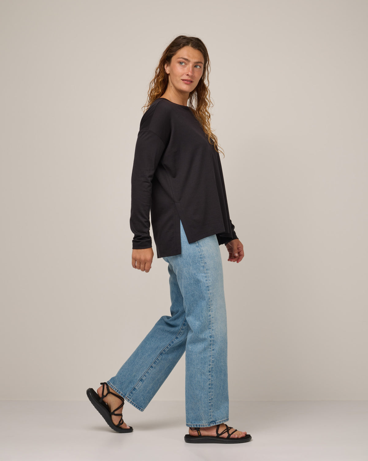 Model wearing Abby Boatneck Top in Black. Abby Boatneck Top is a merino wool long sleeve, boatneck, relaxed fit top available in sizes XS-3X.
