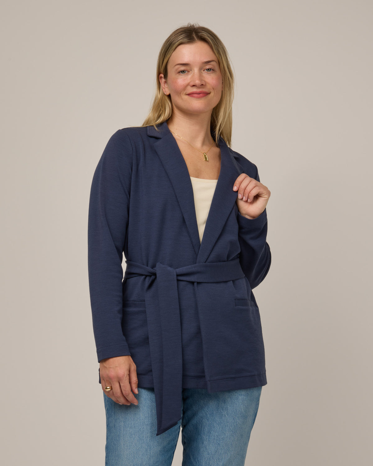 Model wearing Kristen Blazer in Washed Navy. Kristen Blazer is a merino wool long sleeve, collared, regular fit jacket with pockets available in sizes XS-XXL.