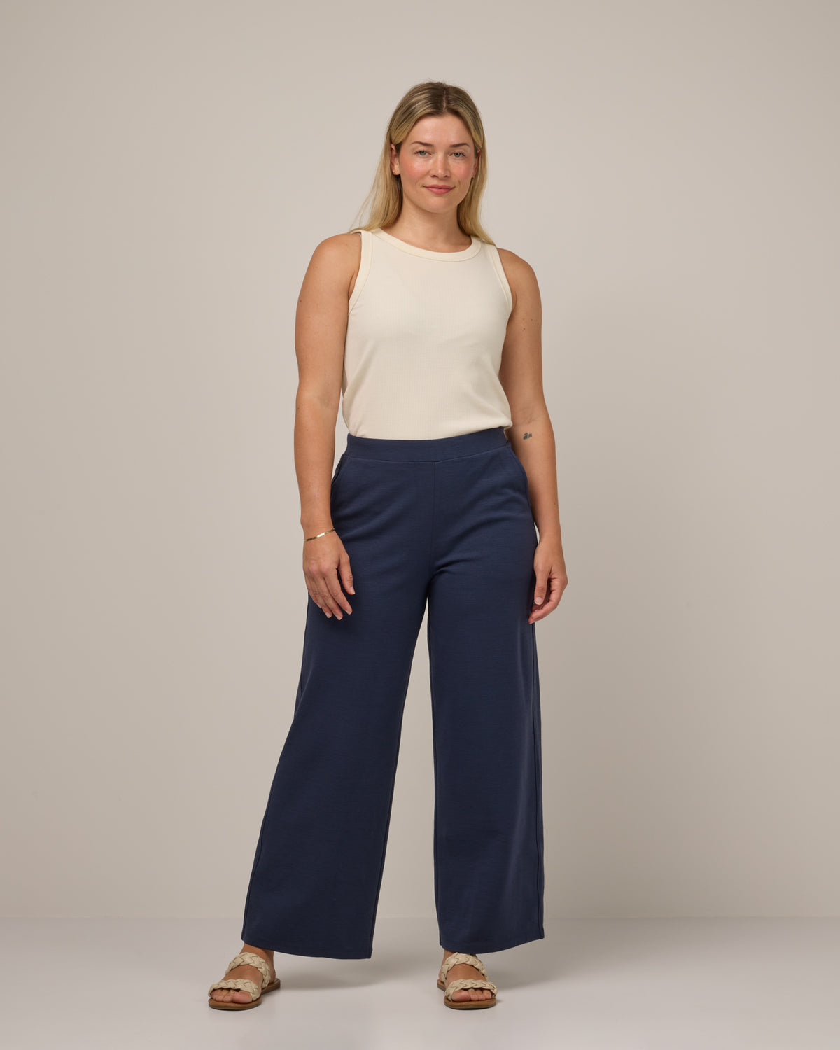 Model wearing Lane Wide Leg Ponte Pant in Washed Navy. Lane Wide Leg Ponte Pant is a merino wool pant with pockets available in sizes XS-3X Regular, XS-XXL Long.