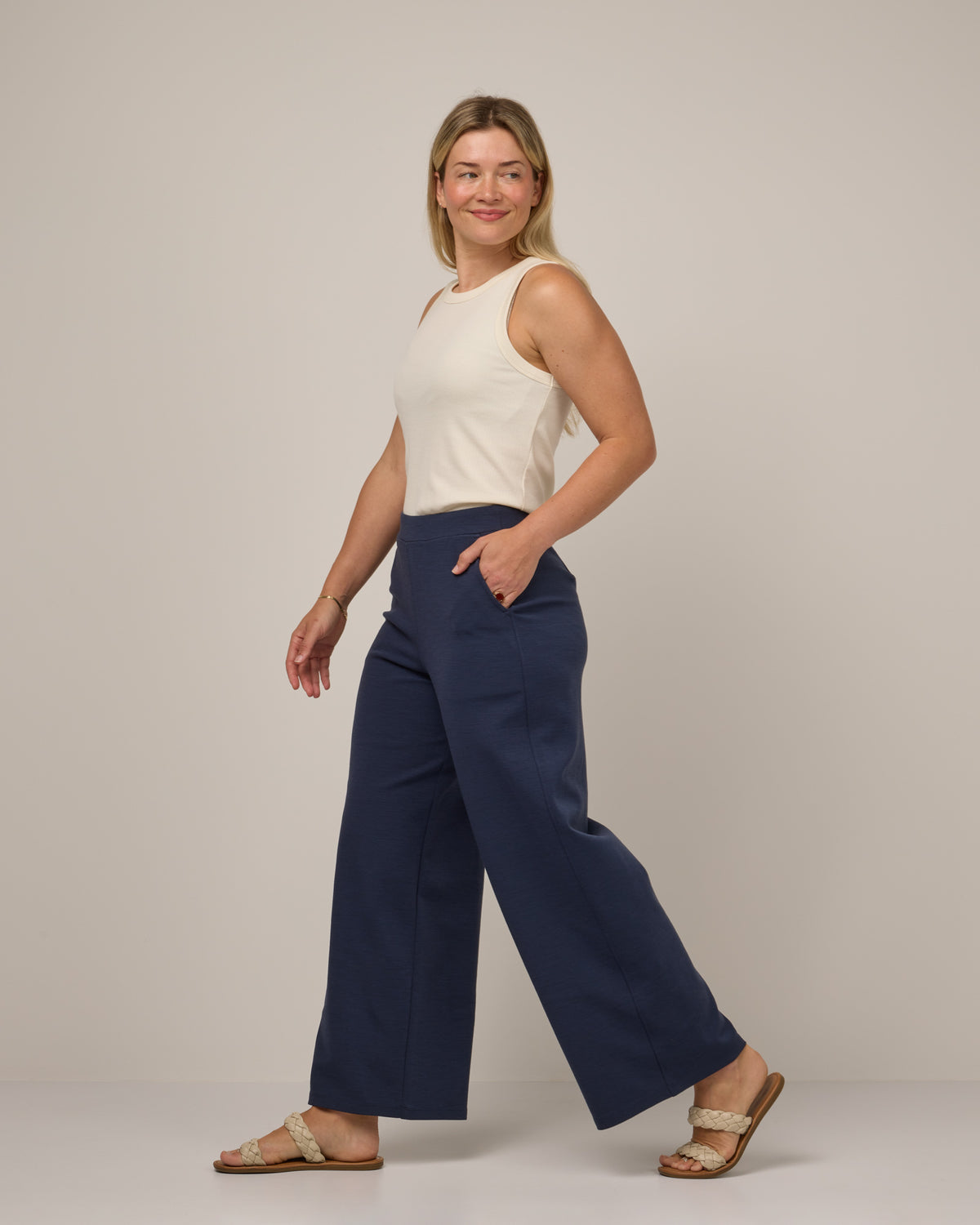 Model wearing Lane Wide Leg Ponte Pant in Washed Navy. Lane Wide Leg Ponte Pant is a merino wool pant with pockets available in sizes XS-3X Regular, XS-XXL Long.