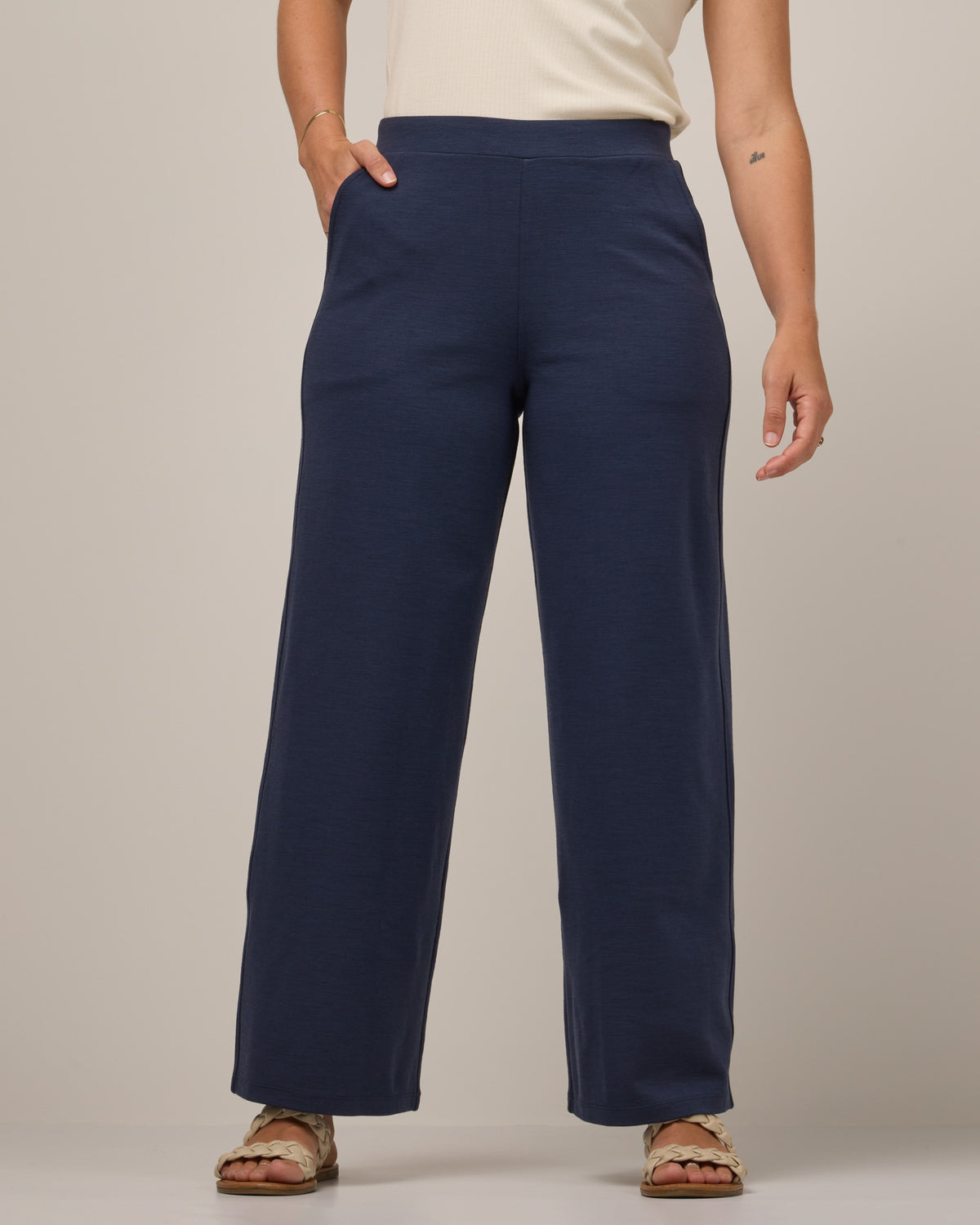 Model wearing Lane Wide Leg Ponte Pant in Washed Navy. Lane Wide Leg Ponte Pant is a merino wool pant with pockets available in sizes XS-3X Regular, XS-XXL Long.