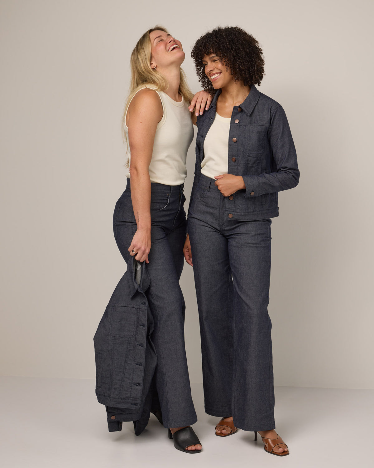 Model wearing Beck Wide Leg Denim Jean in Indigo Blue. Beck Wide Leg Denim Jean is a merino wool pant with pockets available in sizes 26-42.