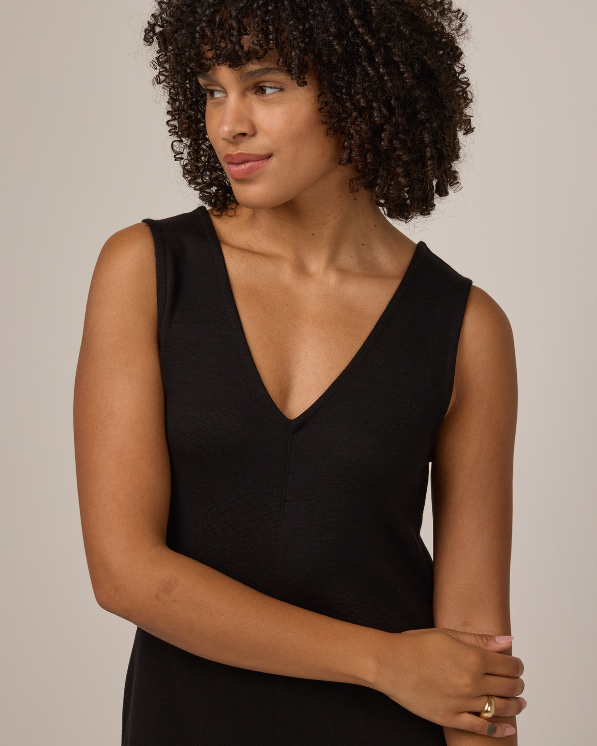 Model wearing Jessa Reversible Dress in Black. Jessa Reversible Dress is a merino wool sleeveless, reversible, midi shift dress with pockets available in sizes XS-3X.