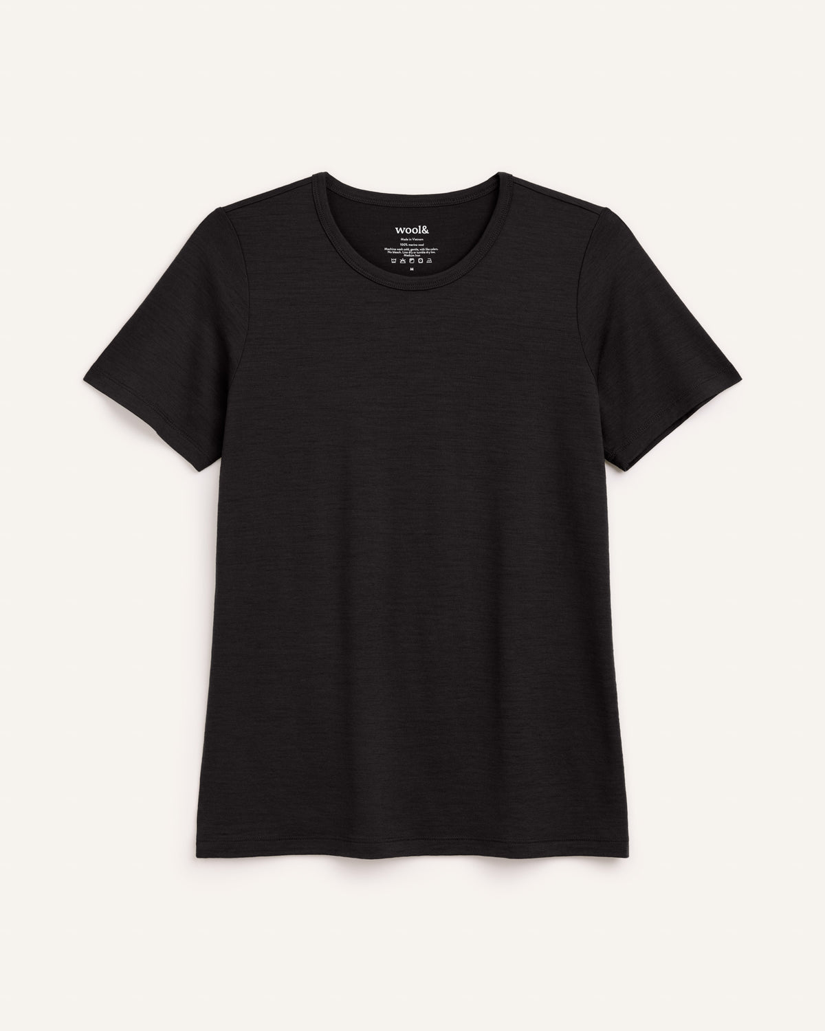Laydown of Cara 100% Wool Fitted Tee in Black. Cara 100% Wool Fitted Tee is a merino wool short sleeve, crew neck, slim fit tee available in sizes XS-3X.