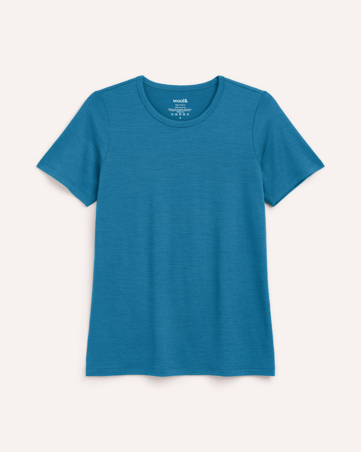 Laydown of Cara 100% Wool Fitted Tee in Ocean Teal, a medium blue-green color. Cara 100% Wool Fitted Tee is a merino wool short sleeve, crew neck, slim fit tee available in sizes XS-3X.