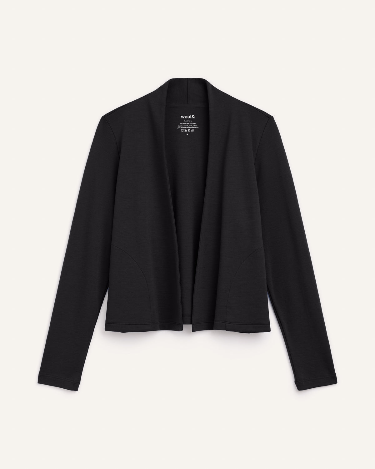 Laydown of Winona Crop Cardigan in Black. Winona Crop Cardigan is a merino wool cardigan with pockets available in sizes XS-XXL.