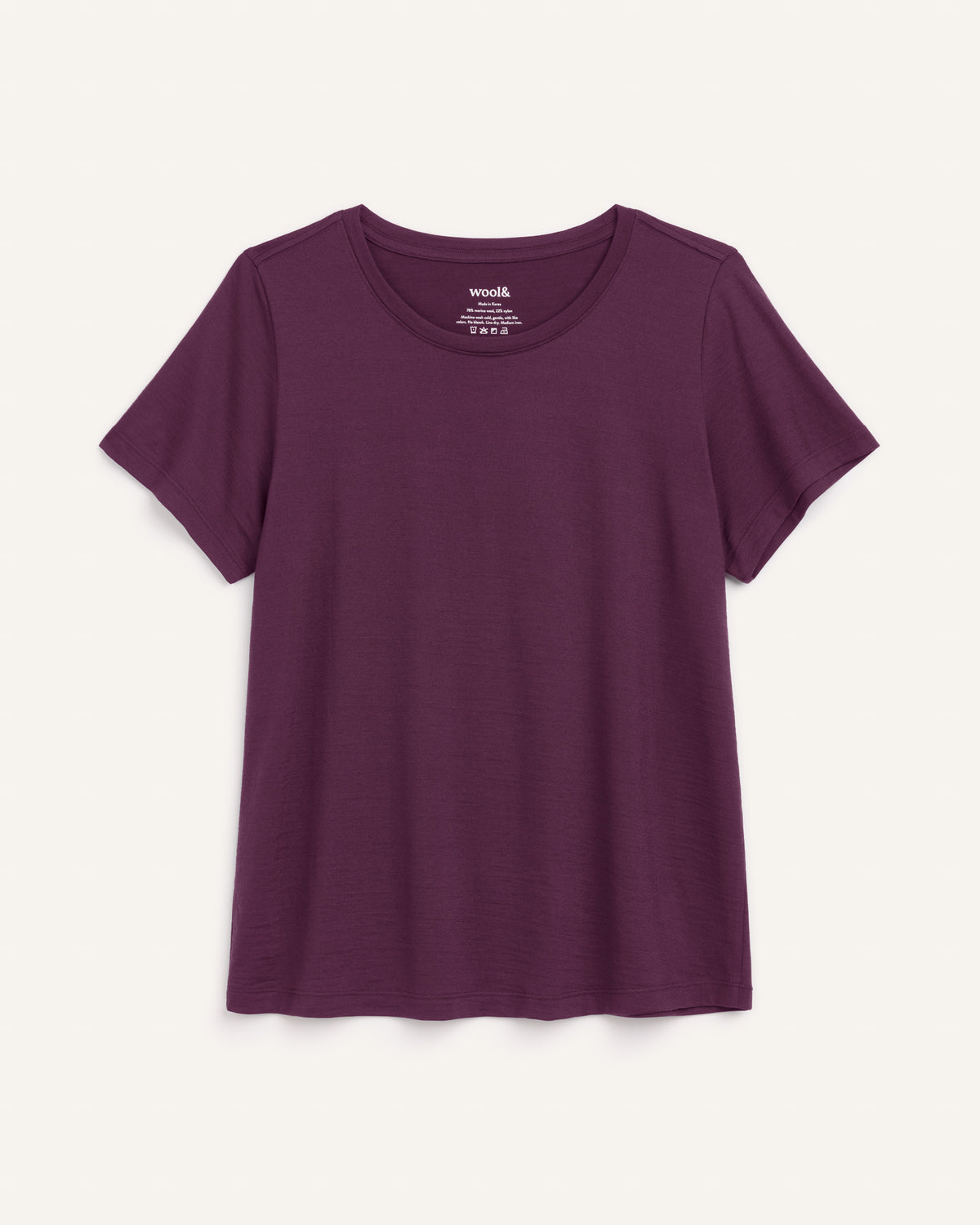 Laydown of Zoe Easy Crew Neck Tee in Marionberry, a dark berry purple color. Zoe Easy Crew Neck Tee is a merino wool short sleeve, crew neck, regular fit tee available in sizes XS-3X.