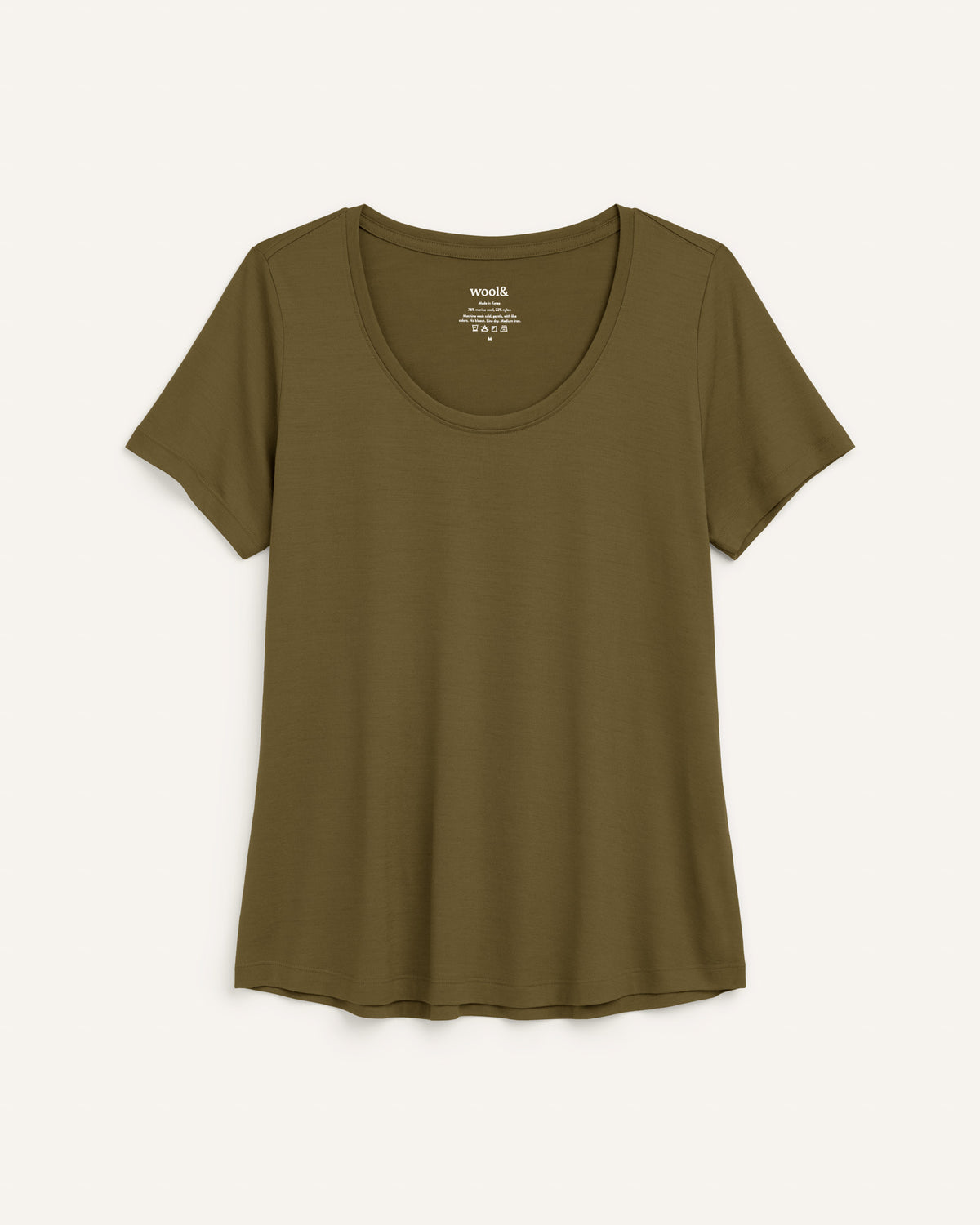Laydown of Stella Signature Scoop Neck Tee in Olive. Stella Signature Scoop Neck Tee is a merino wool short sleeve, scoop neck, relaxed fit tee available in sizes XS-3X.