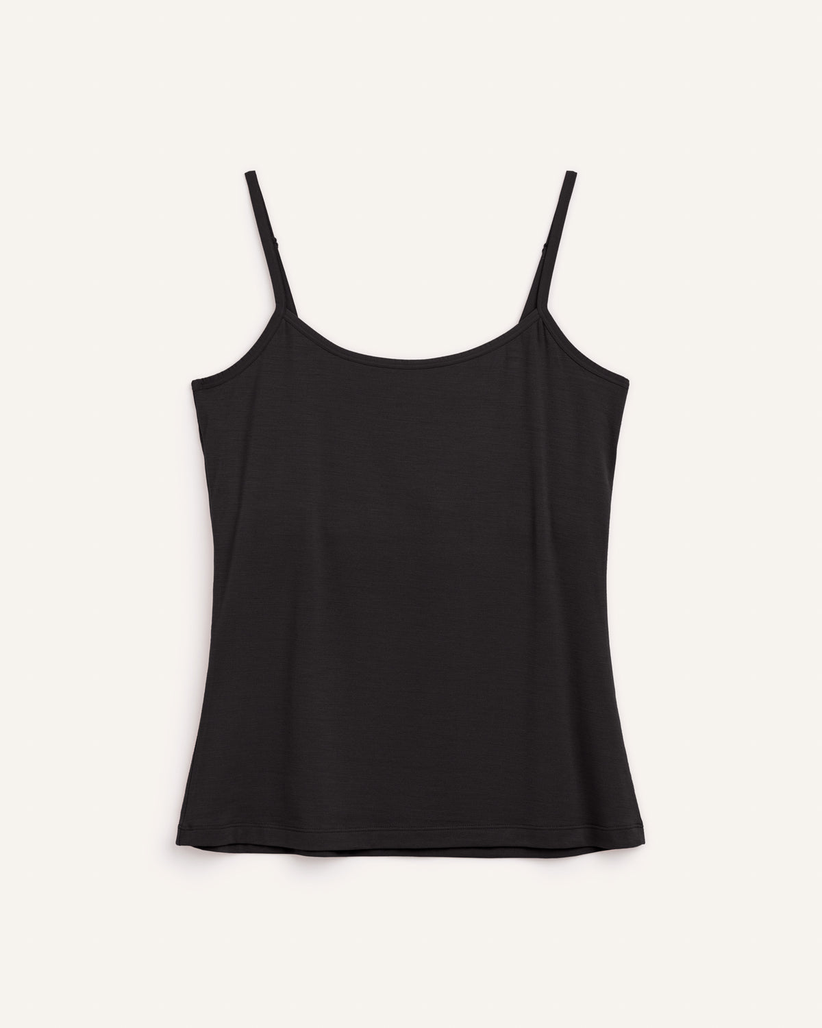 Laydown of Roam Shelf Bra Cami in Black. Roam Shelf Bra Cami is a merino wool sleeveless, scoop neck, slim fit top available in sizes XS-XXL.