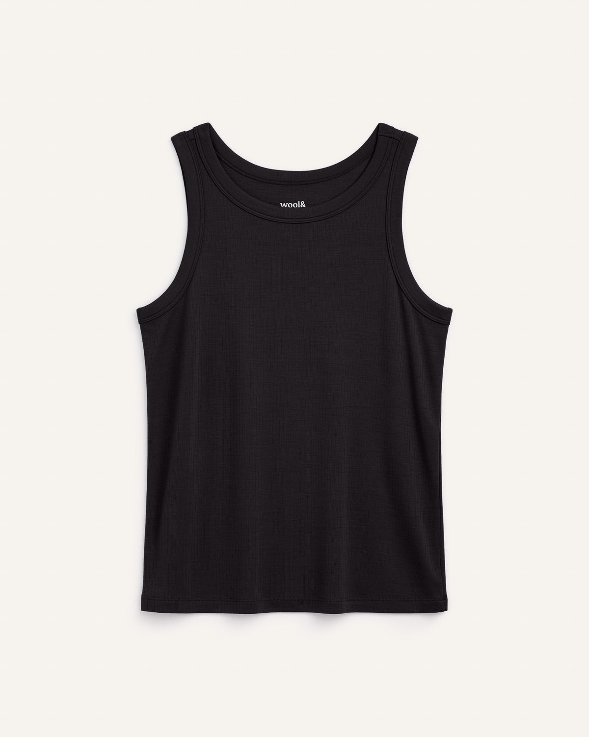 Model wearing Lily Ribbed Tank in Black. Lily Ribbed Tank is a merino wool sleeveless, crew neck, slim fit top available in sizes XS-3X.