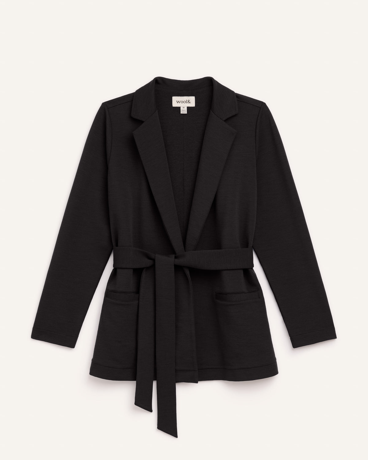 Laydown of Kristen Blazer in Black. Kristen Blazer is a merino wool long sleeve, collared, regular fit jacket with pockets available in sizes XS-XXL.