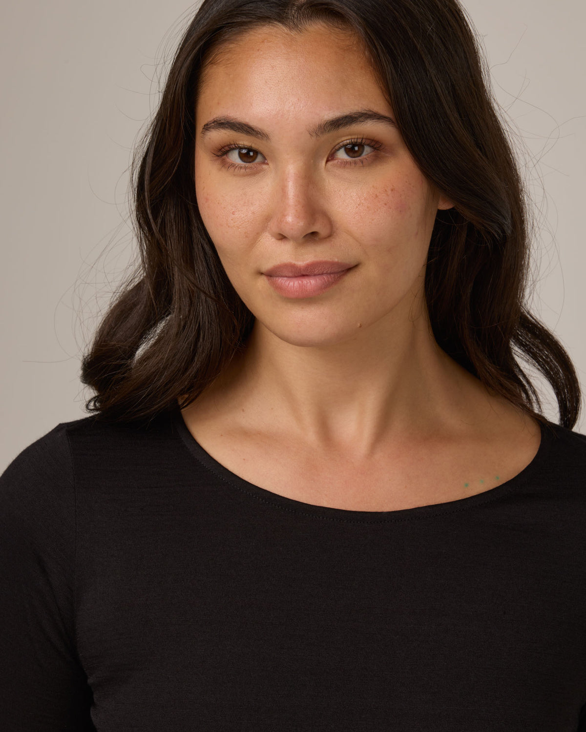 Model wearing Colette Quarter-Sleeve Top in Black. Colette Quarter-Sleeve Top is a merino wool long sleeve, boatneck, regular fit top available in sizes XS-3X.