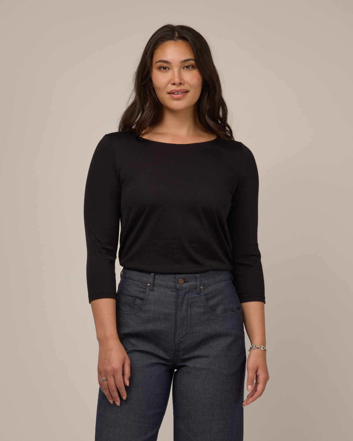 Model wearing Colette Quarter-Sleeve Top in Black. Colette Quarter-Sleeve Top is a merino wool long sleeve, boatneck, regular fit top available in sizes XS-3X.