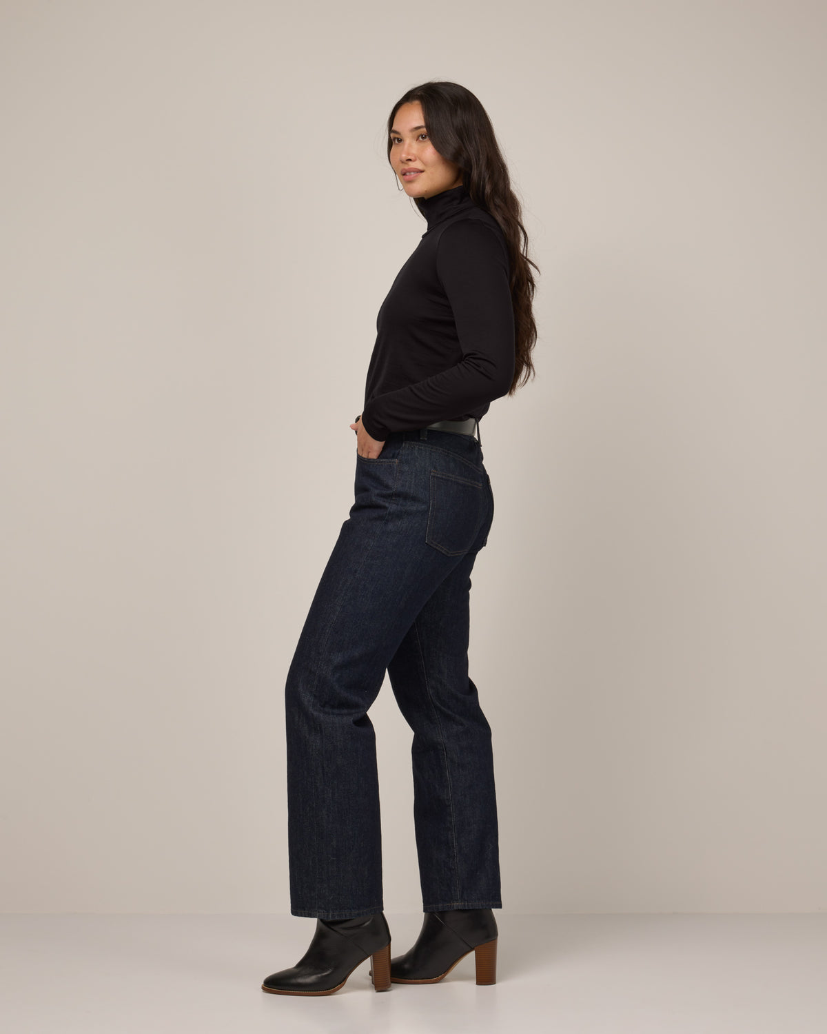 Model wearing Addison Turtleneck Top in Black. Addison Turtleneck Top is a merino wool long sleeve, turtleneck, slim fit top available in sizes XS-3X.