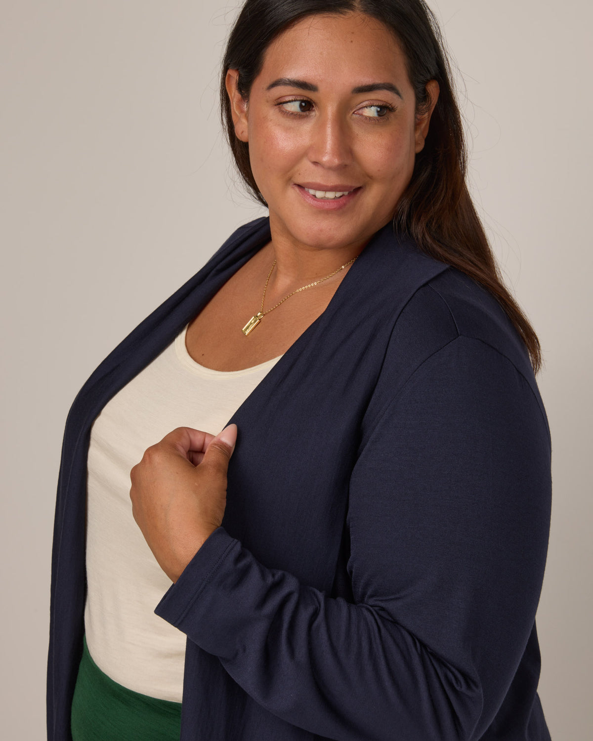 Model wearing Landmark Cardigan in Washed Navy. Landmark Cardigan is a merino wool long sleevecardigan with pockets available in sizes XS-3X.