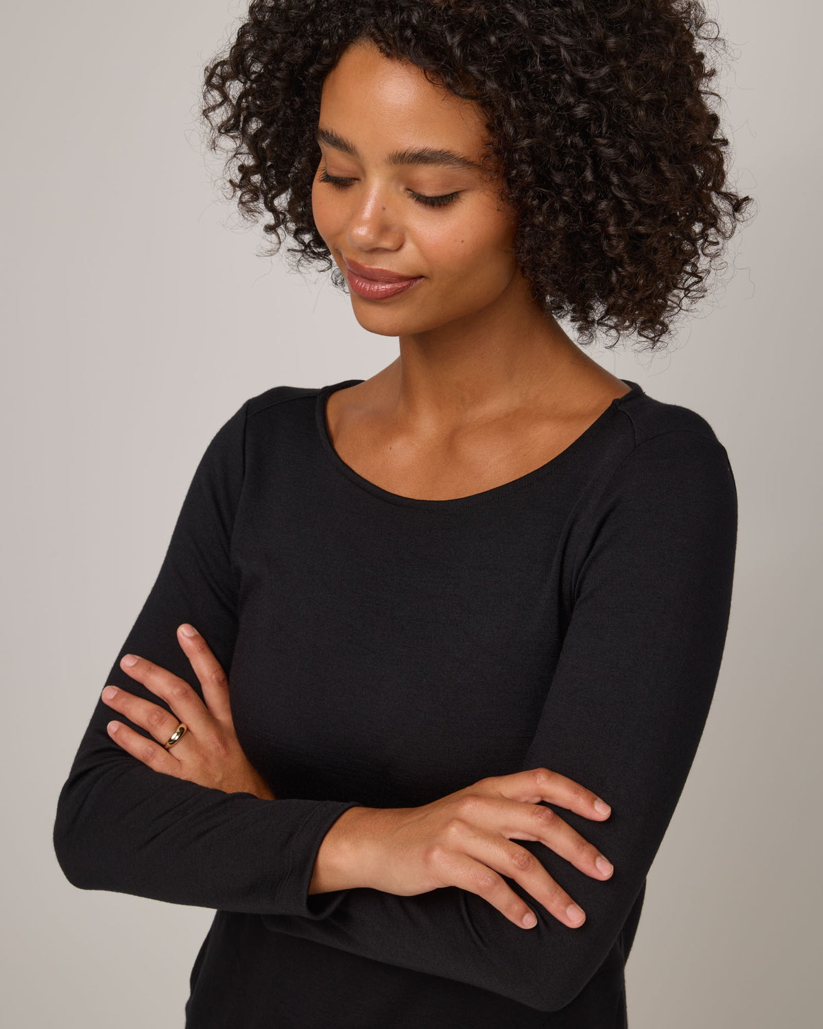 Model wearing Margo Shift Dress in Black. Margo Shift Dress is a merino wool long sleeve, boatneck, knee length shift dress with pockets available in sizes XS-3X Regular, S-3X Long.