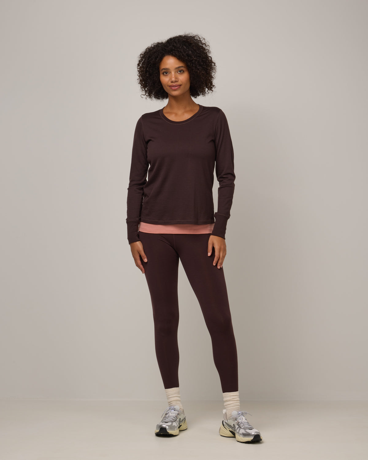 Model wearing Summit Legging in Espresso, a dark brown color. Summit Legging is a merino wool legging available in sizes XS-3X Regular, S-XXL Long.