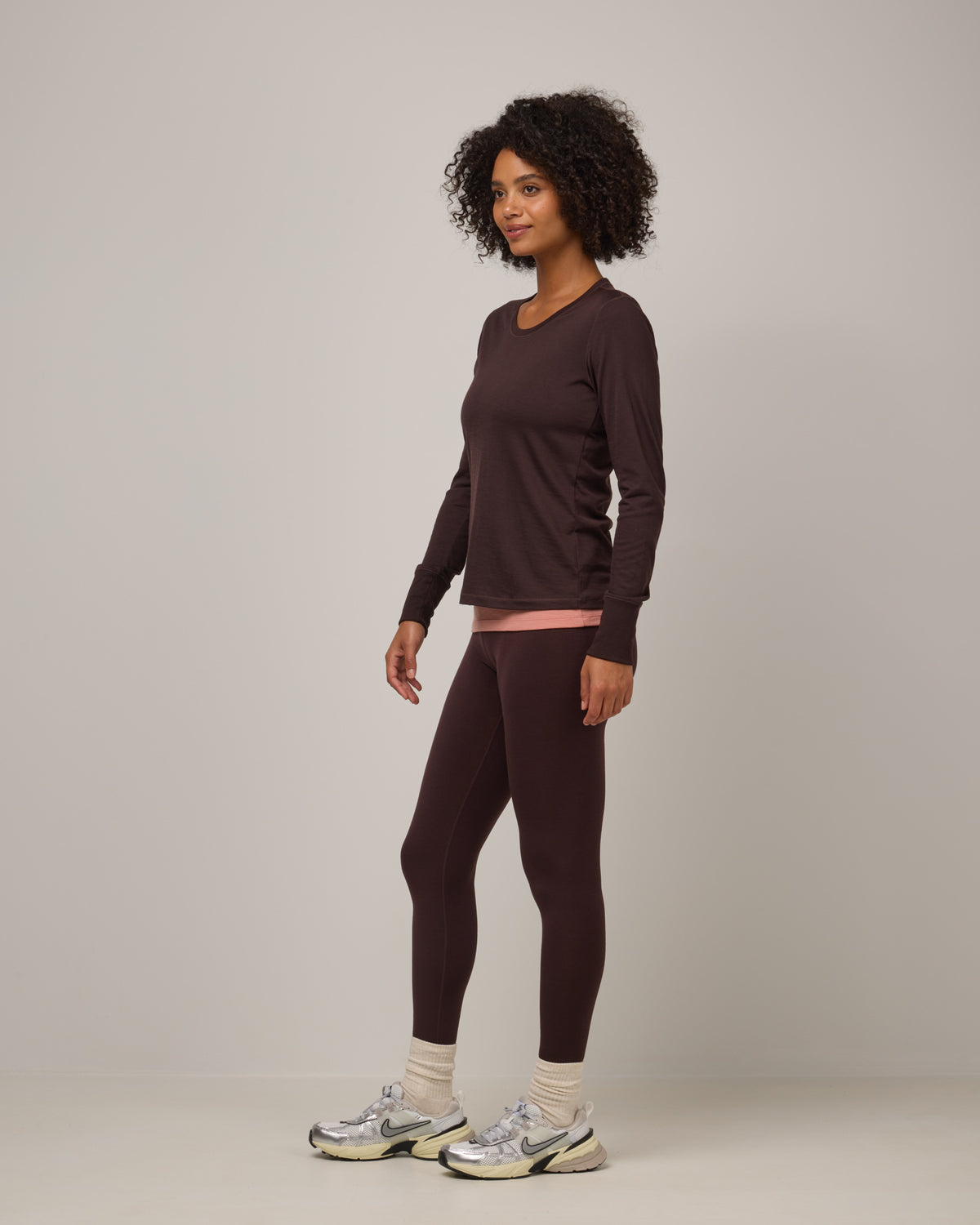 Model wearing Summit Legging in Espresso, a dark brown color. Summit Legging is a merino wool legging available in sizes XS-3X Regular, S-XXL Long.