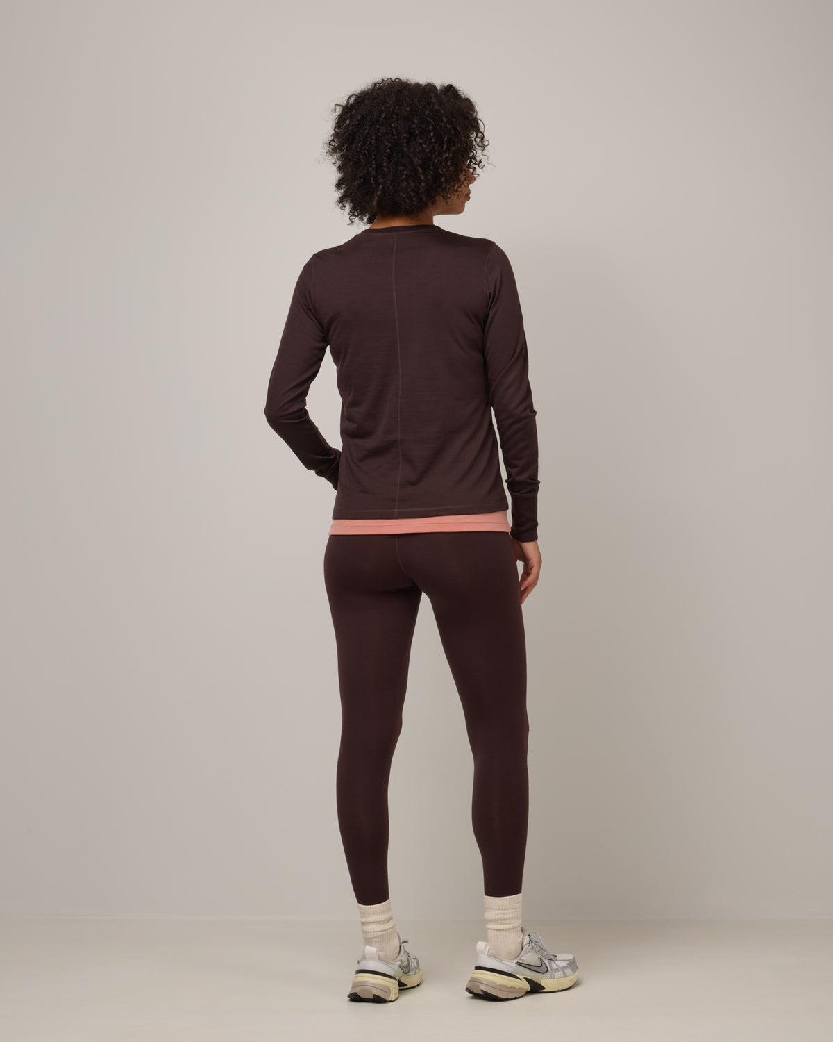 Model wearing Summit Legging in Espresso, a dark brown color. Summit Legging is a merino wool legging available in sizes XS-3X Regular, S-XXL Long.