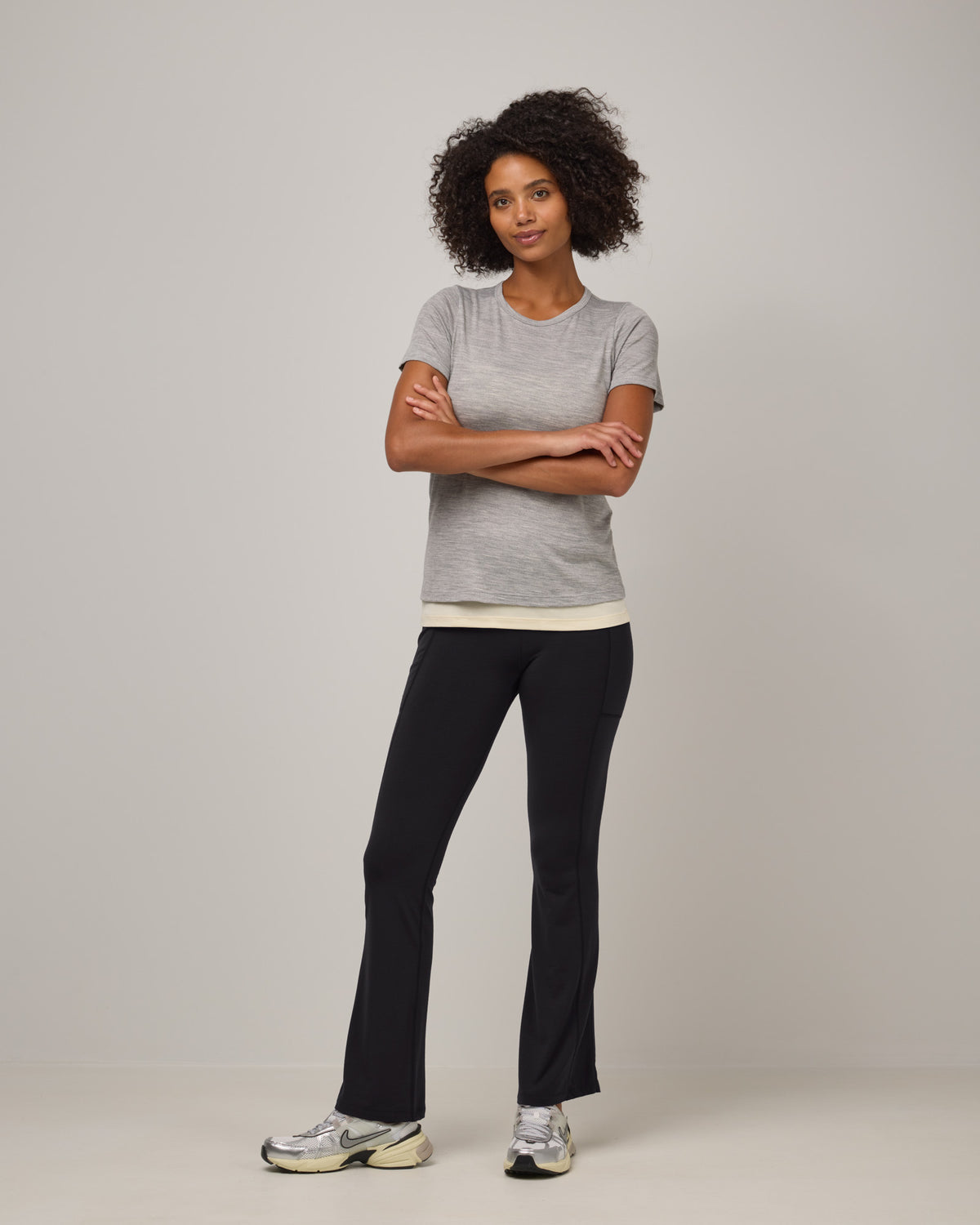 Model wearing Summit Straight Cut Pocket Legging in Black. Summit Straight Cut Pocket Legging is a merino wool legging with pockets available in sizes XS-3X Regular, S-XXL Long.