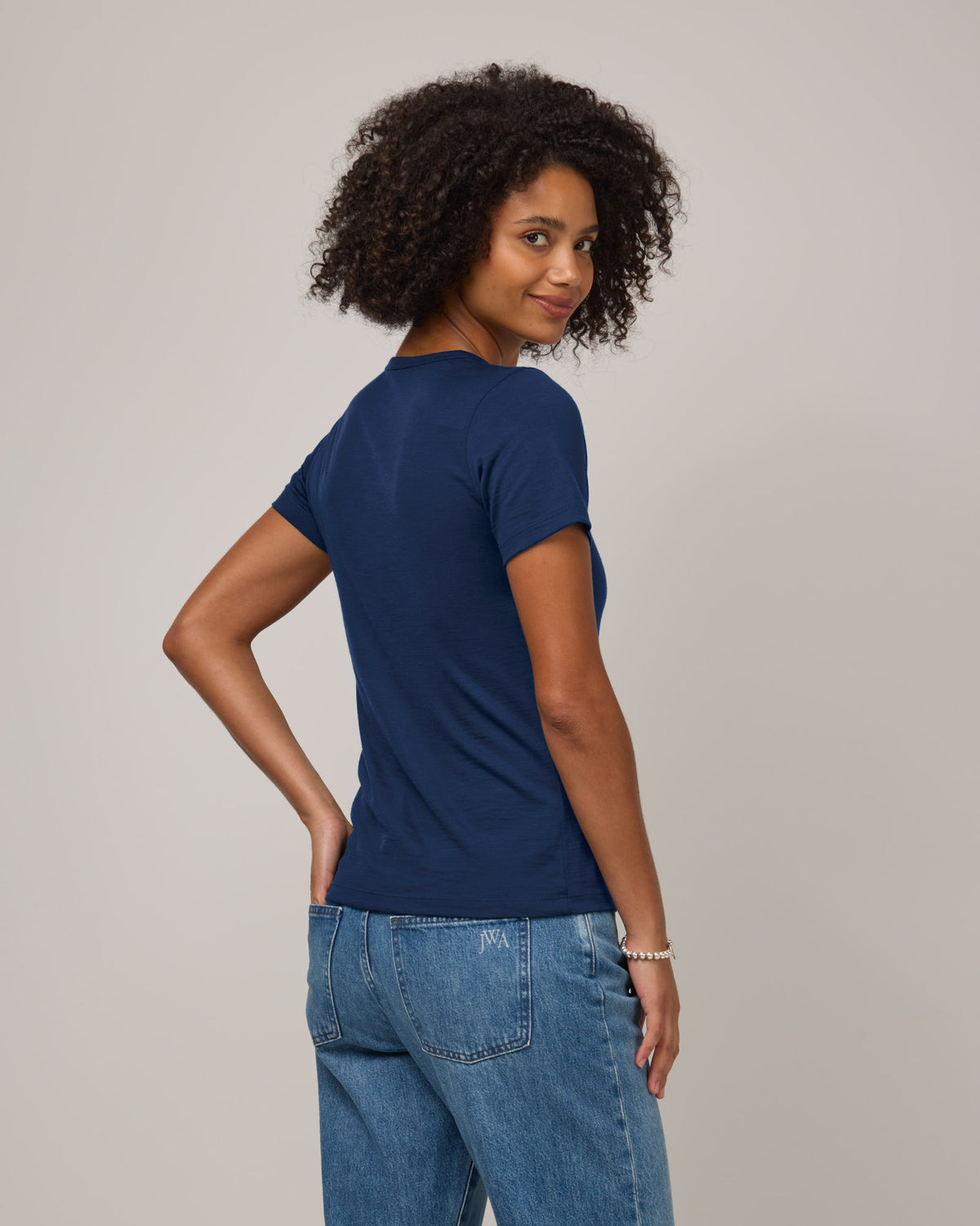Model wearing Cara Signature Fitted Tee in Marine Blue, a dark royal blue color. Cara Signature Fitted Tee is a merino wool short sleeve, crew neck, slim fit tee available in sizes XS-3X.