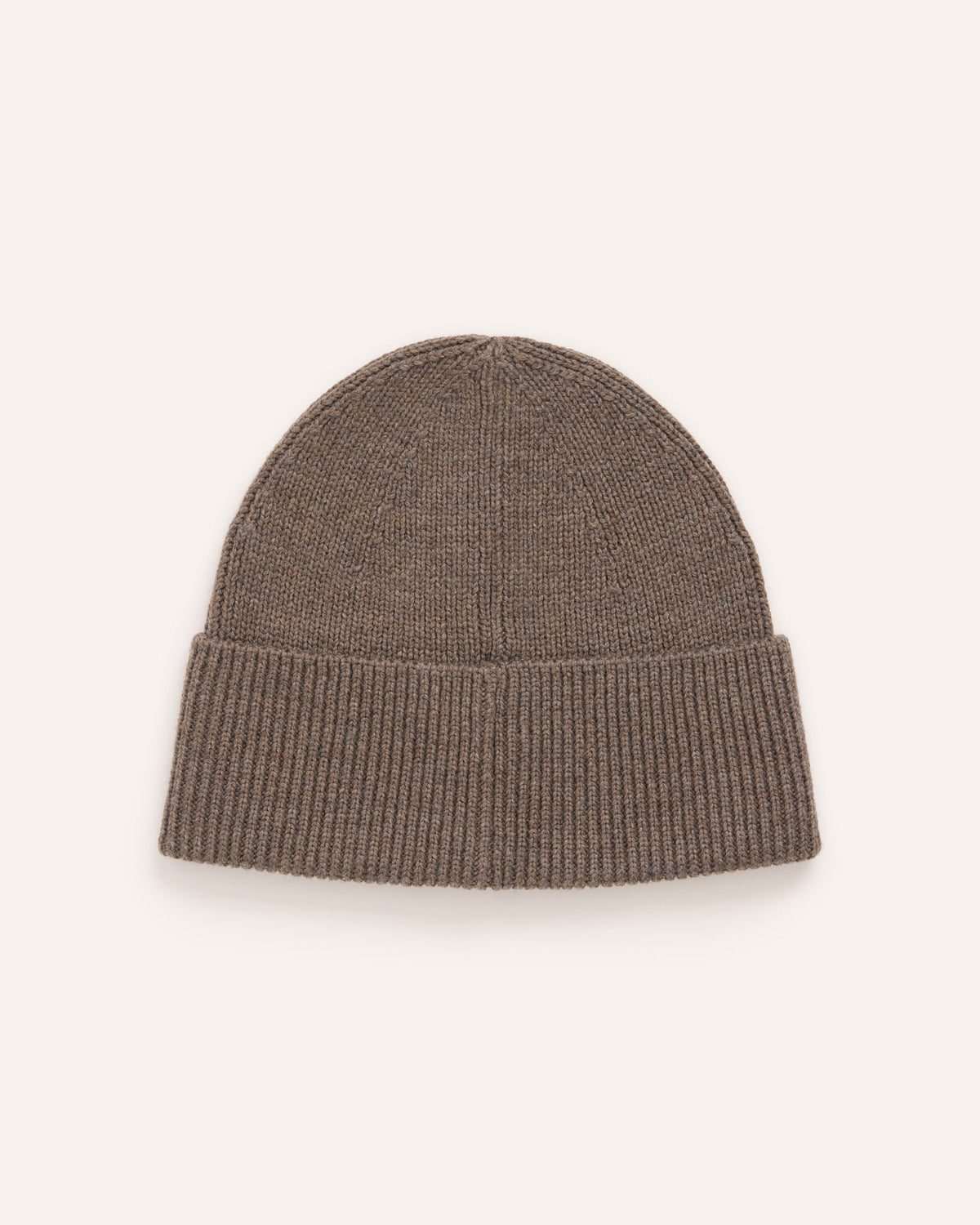 Laydown of Rory Ribbed Beanie in . Rory Ribbed Beanie is a merino wool hat available in one size.