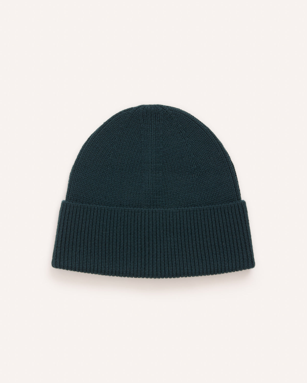 Laydown of Rory Ribbed Beanie in . Rory Ribbed Beanie is a merino wool hat available in one size.
