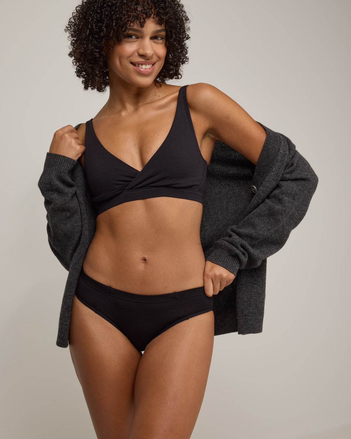 Model wearing Roam Bikini in Black. Roam Bikini is a merino wool underwear available in sizes XS-3X.