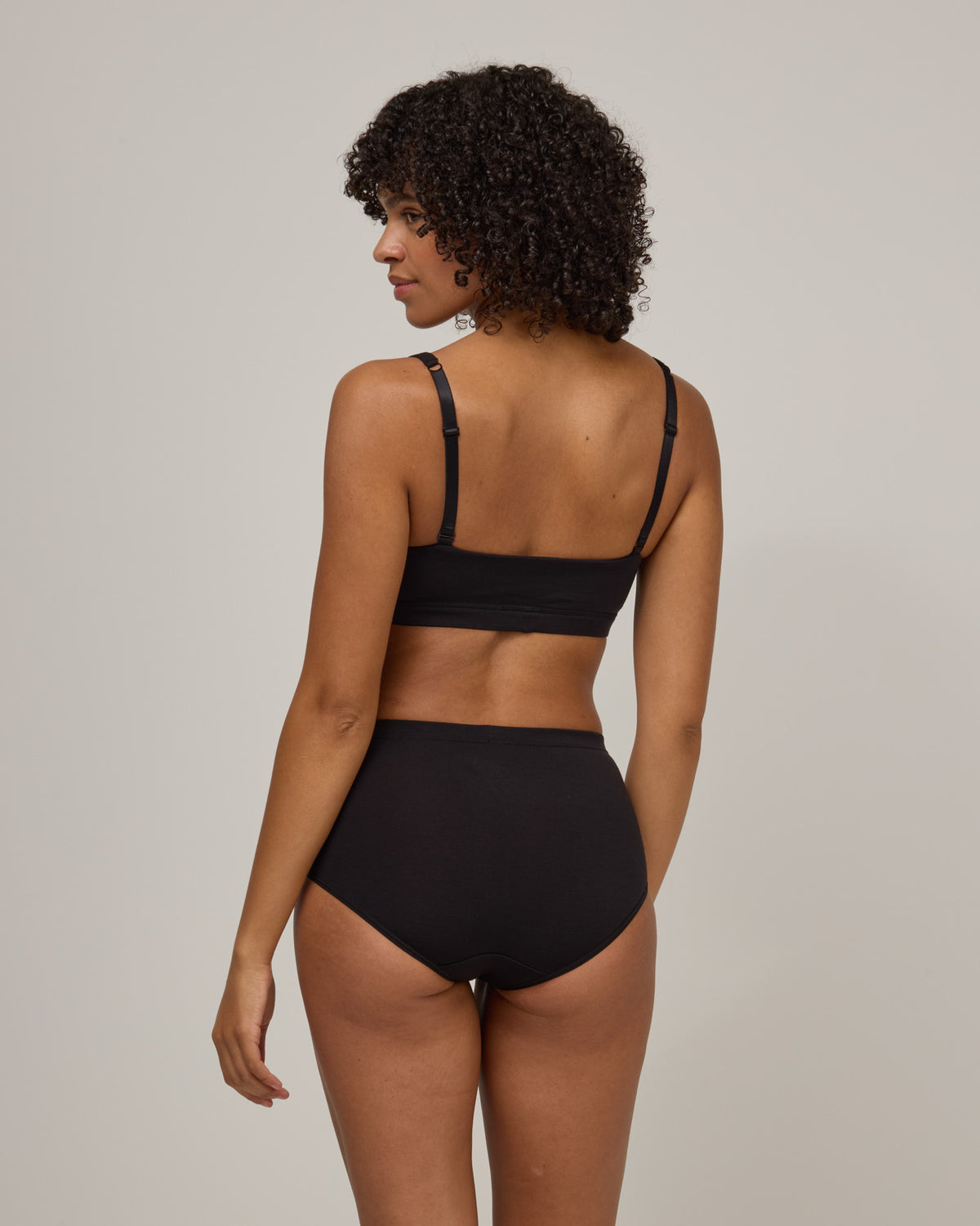 Model wearing Roam High Waist Bikini in Black. Roam High Waist Bikini is a merino wool underwear available in sizes XS-3X.