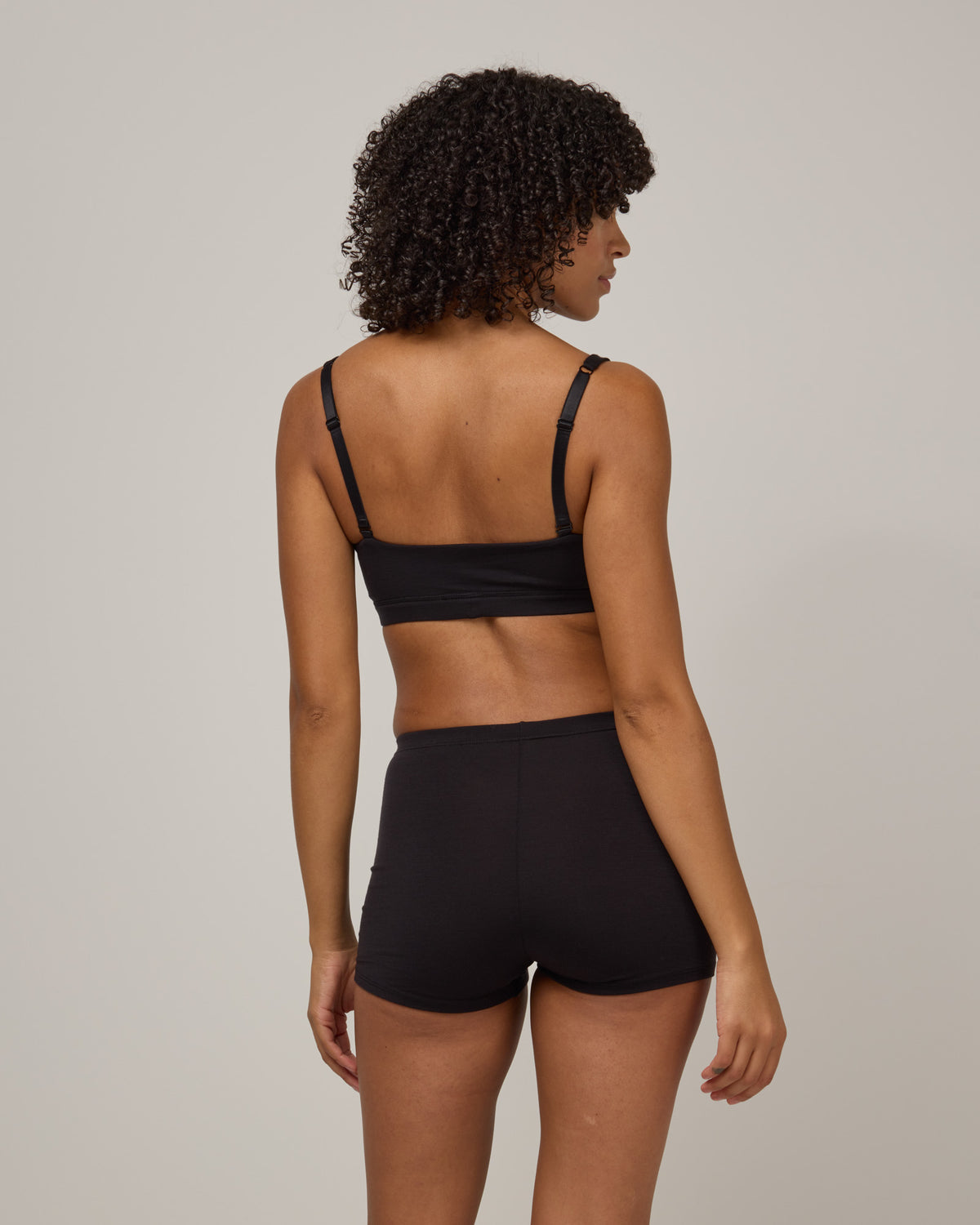 Model wearing Roam High Waist Shortie in Black. Roam High Waist Shortie is a merino wool underwear available in sizes XS-3X.