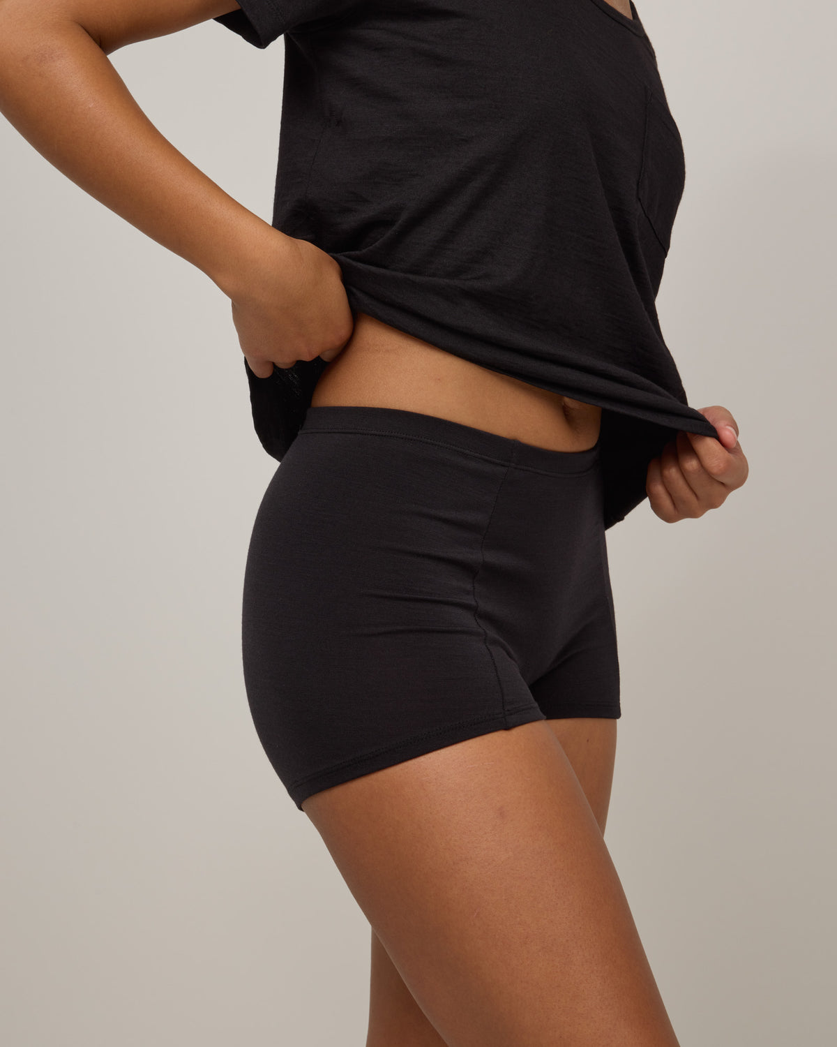 Model wearing Roam High Waist Shortie in Black. Roam High Waist Shortie is a merino wool underwear available in sizes XS-3X.