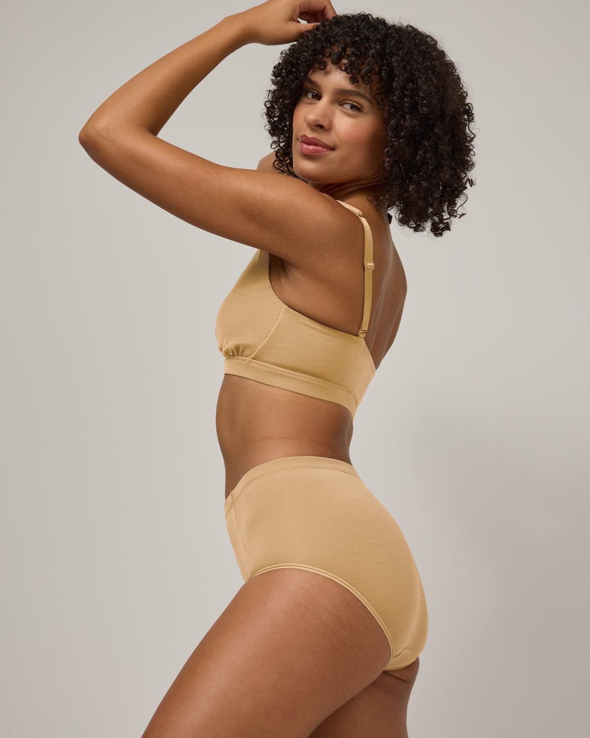 Model wearing Roam High Waist Bikini in Fawn, a light nude color. Roam High Waist Bikini is a merino wool underwear available in sizes XS-3X.