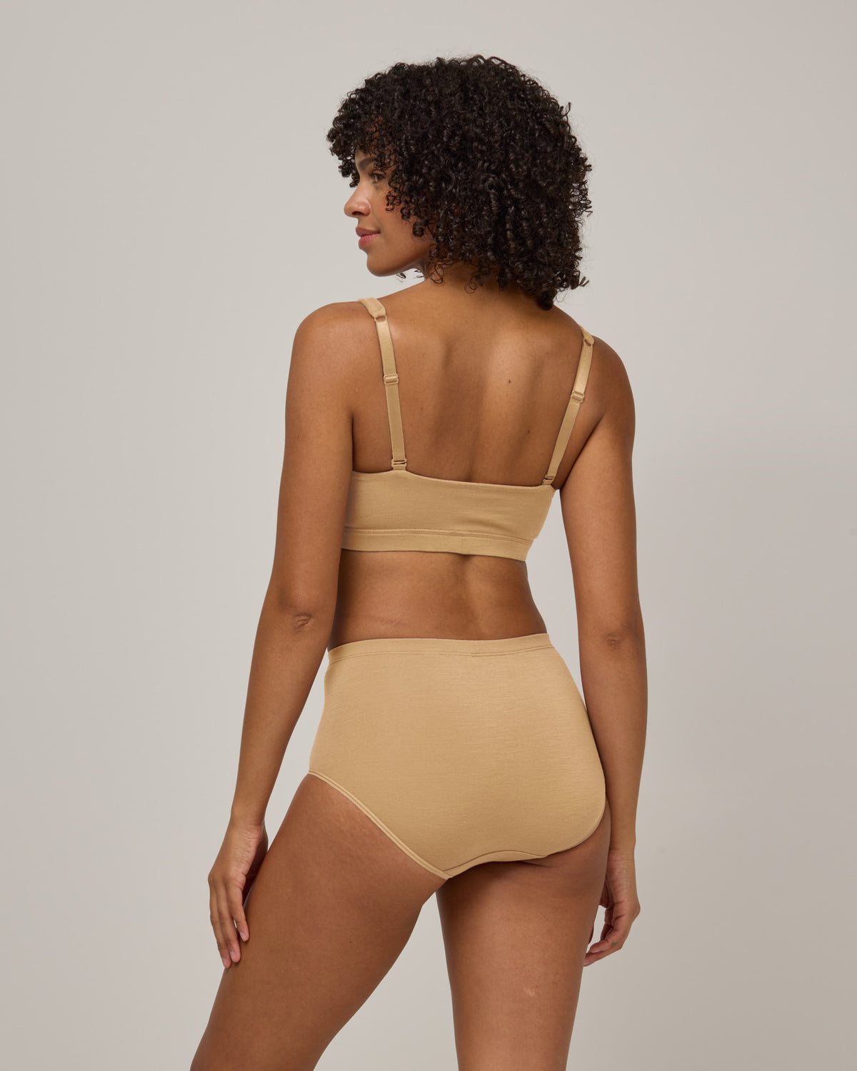 Model wearing Roam High Waist Bikini in Fawn, a light nude color. Roam High Waist Bikini is a merino wool underwear available in sizes XS-3X.