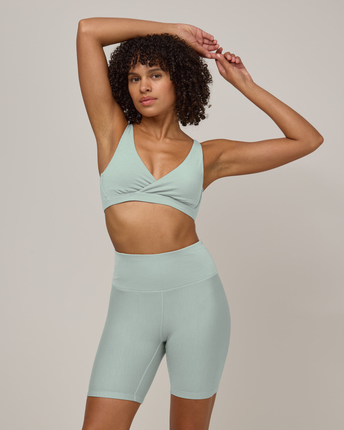 Model wearing Roam Bike Short in Morning Dew, a vivid mint green color. Roam Bike Short is a merino wool short with pockets available in sizes XS-3X.