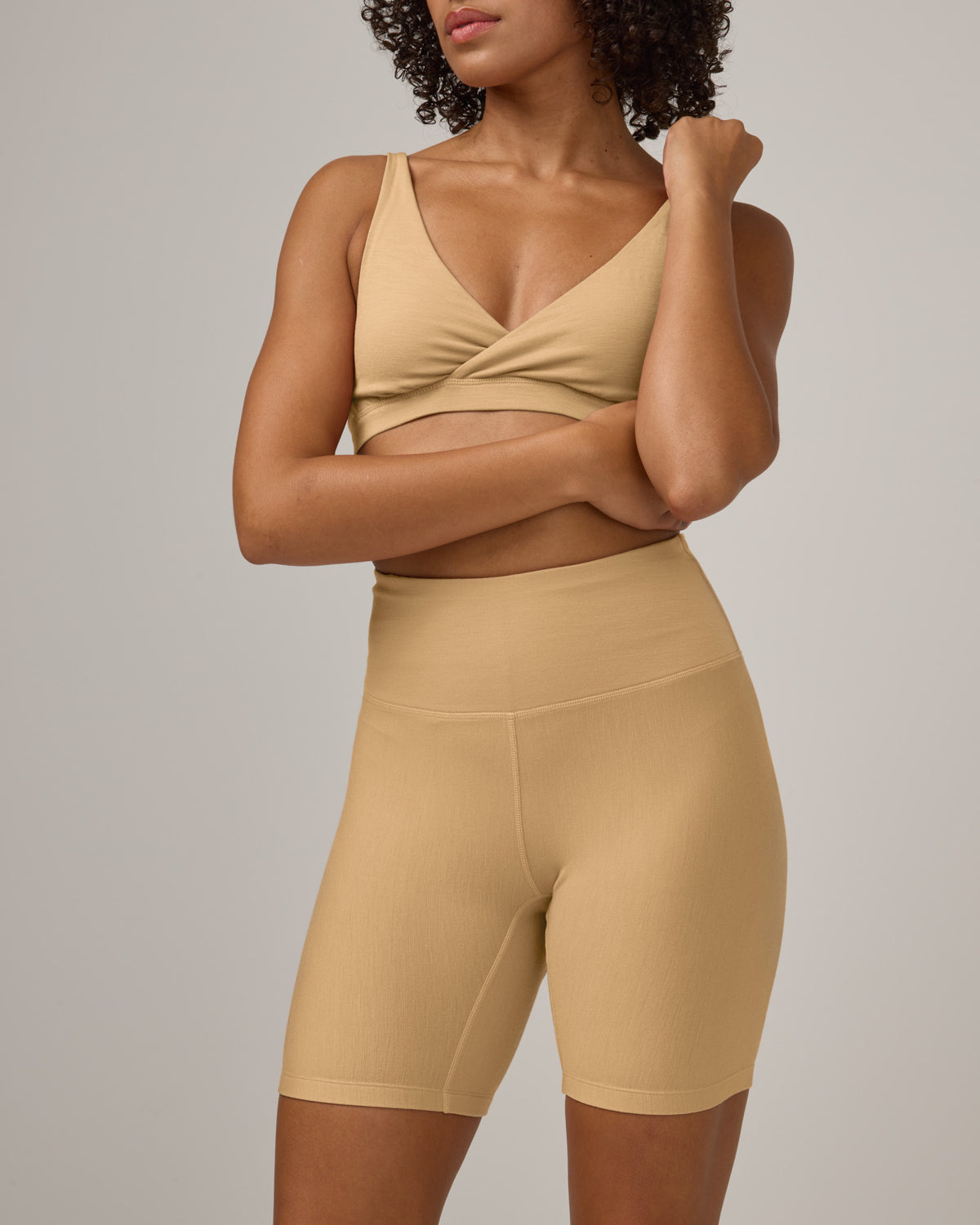 Model wearing Roam Bike Short in Fawn, a light nude color. Roam Bike Short is a merino wool short with pockets available in sizes XS-3X.