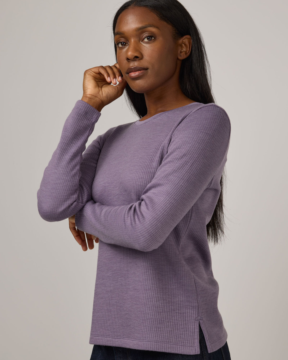 Model wearing Rayne Double Knit Ribbed Top in Purple Sage, a soft, muted purple color. Rayne Double Knit Ribbed Top is a merino wool long sleeve, crew neck, slim fit top available in sizes XS-3X.