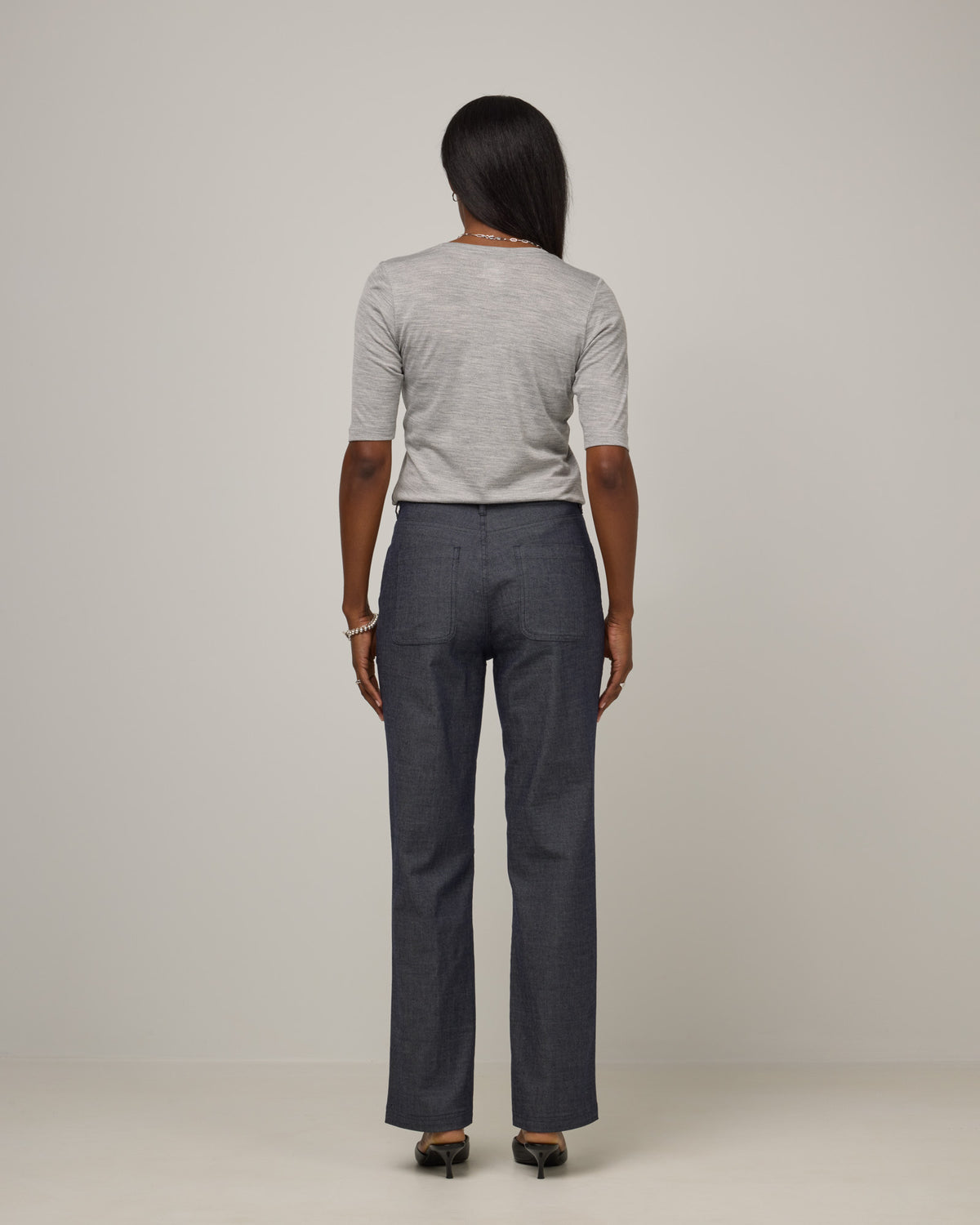 Model wearing Hawthorne Straight Leg Denim Jean in Indigo Blue. Hawthorne Straight Leg Denim Jean is a merino wool pant with pockets available in sizes 26-34.
