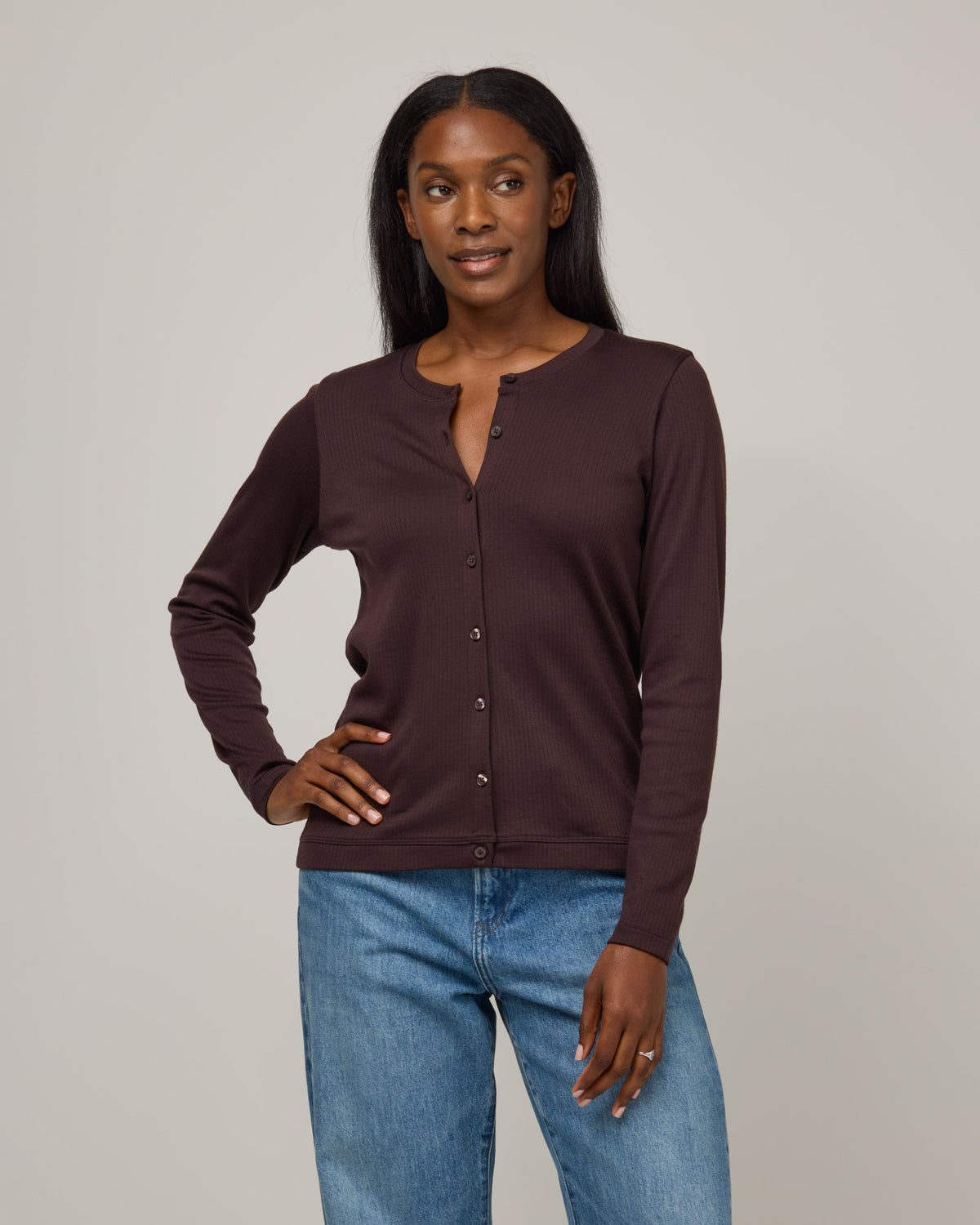 Model wearing Celeste Ribbed Cardigan in Espresso, a dark brown color. Celeste Ribbed Cardigan is a merino wool long sleeve, cardigan available in sizes XS-3X.