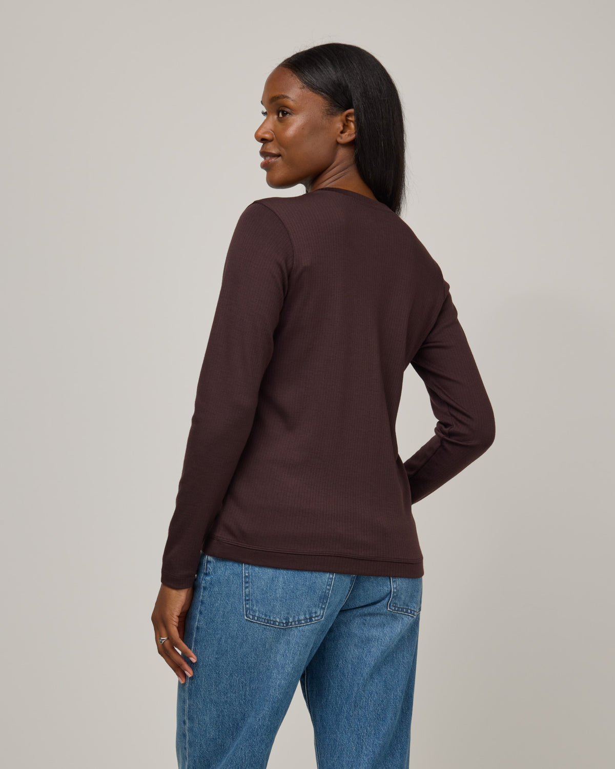 Model wearing Celeste Ribbed Cardigan in Espresso, a dark brown color. Celeste Ribbed Cardigan is a merino wool long sleeve, cardigan available in sizes XS-3X.