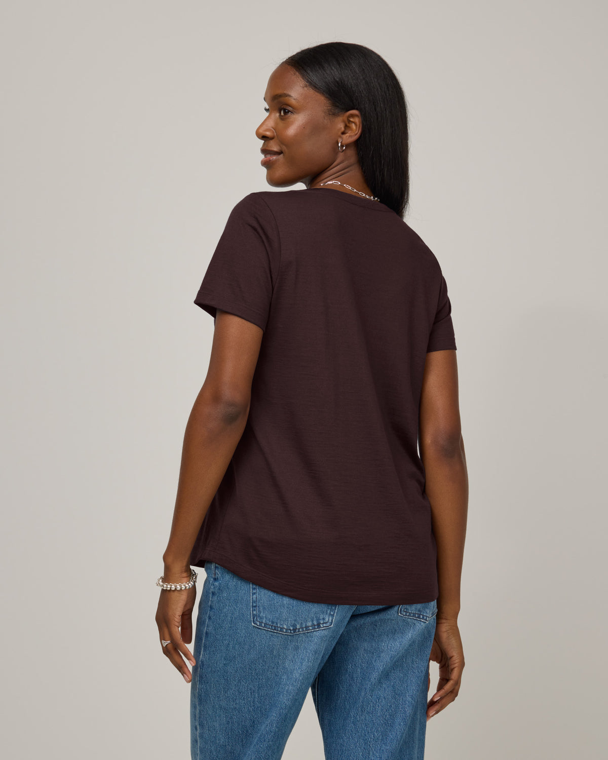 Model wearing Stella Signature Scoop Neck Tee in Espresso, a dark brown color. Stella Signature Scoop Neck Tee is a merino wool short sleeve, scoop neck, relaxed fit tee available in sizes XS-3X.