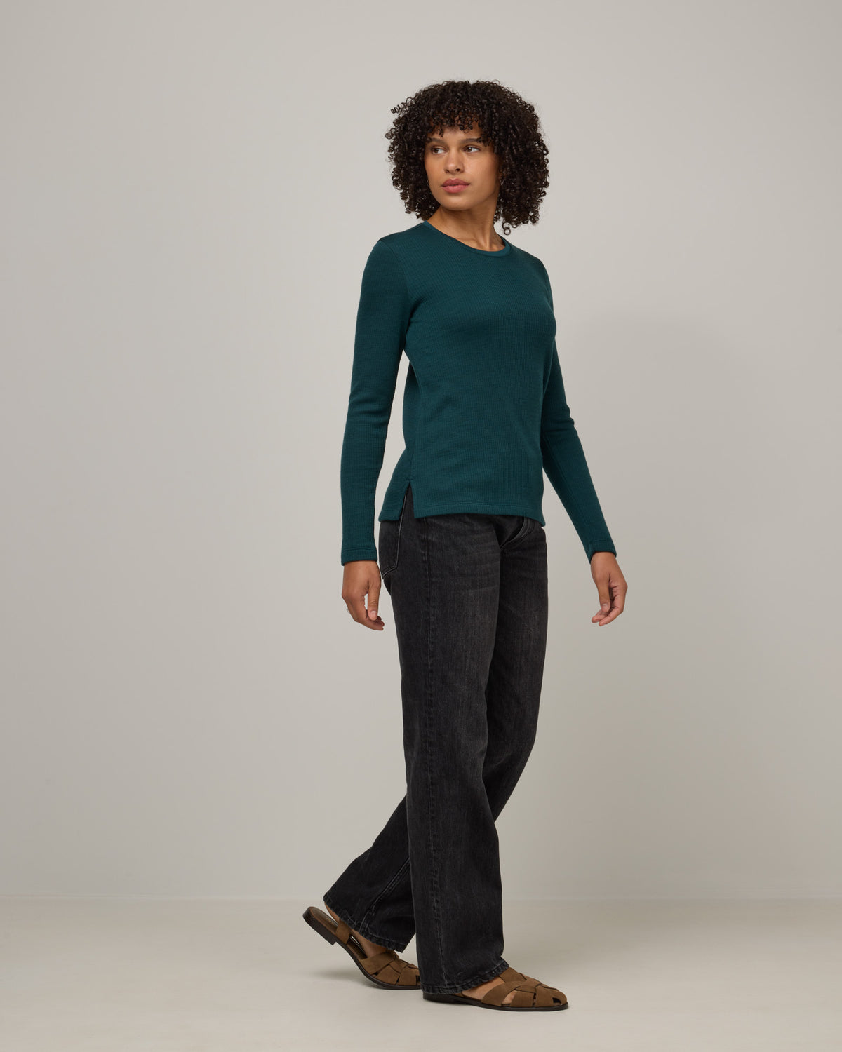 Model wearing Rayne Double Knit Ribbed Top in Pine, a saturated forest green color. Rayne Double Knit Ribbed Top is a merino wool long sleeve, crew neck, slim fit top available in sizes XS-3X.