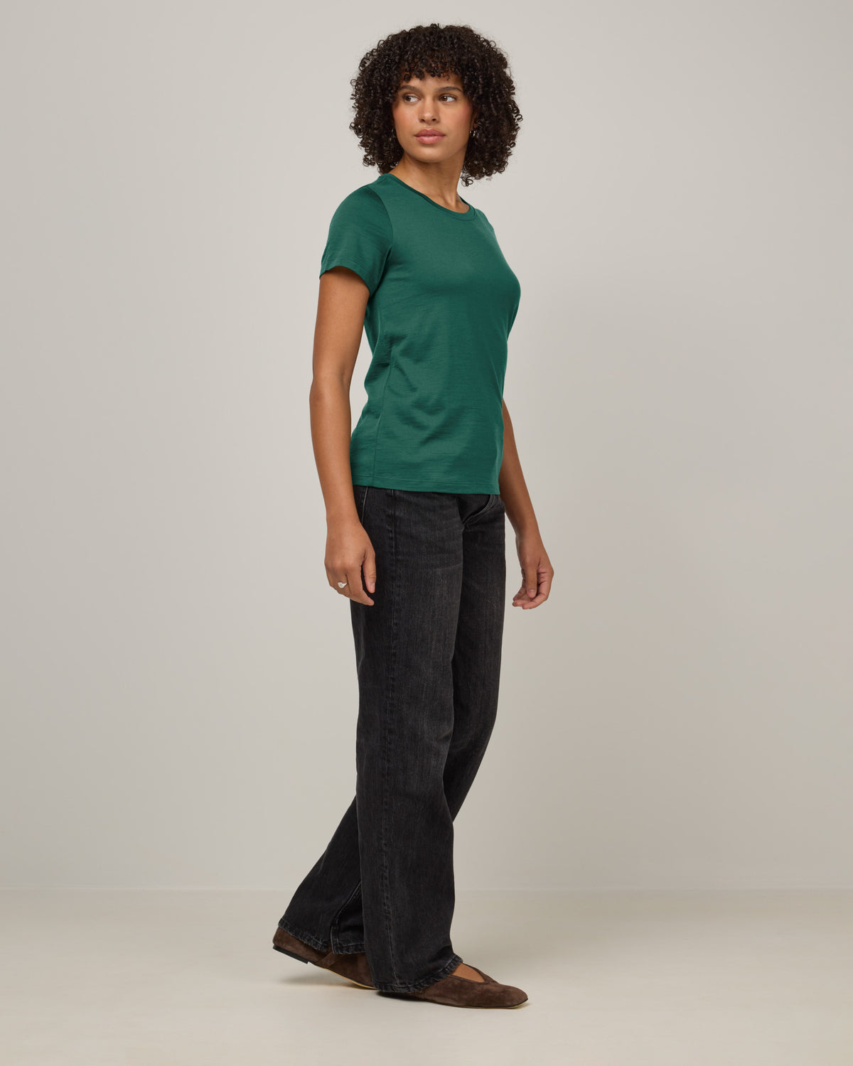 Model wearing Zoe Easy Crew Neck Tee in Emerald green. Zoe Easy Crew Neck Tee is a merino wool short sleeve, crew neck, regular fit tee available in sizes XS-3X.
