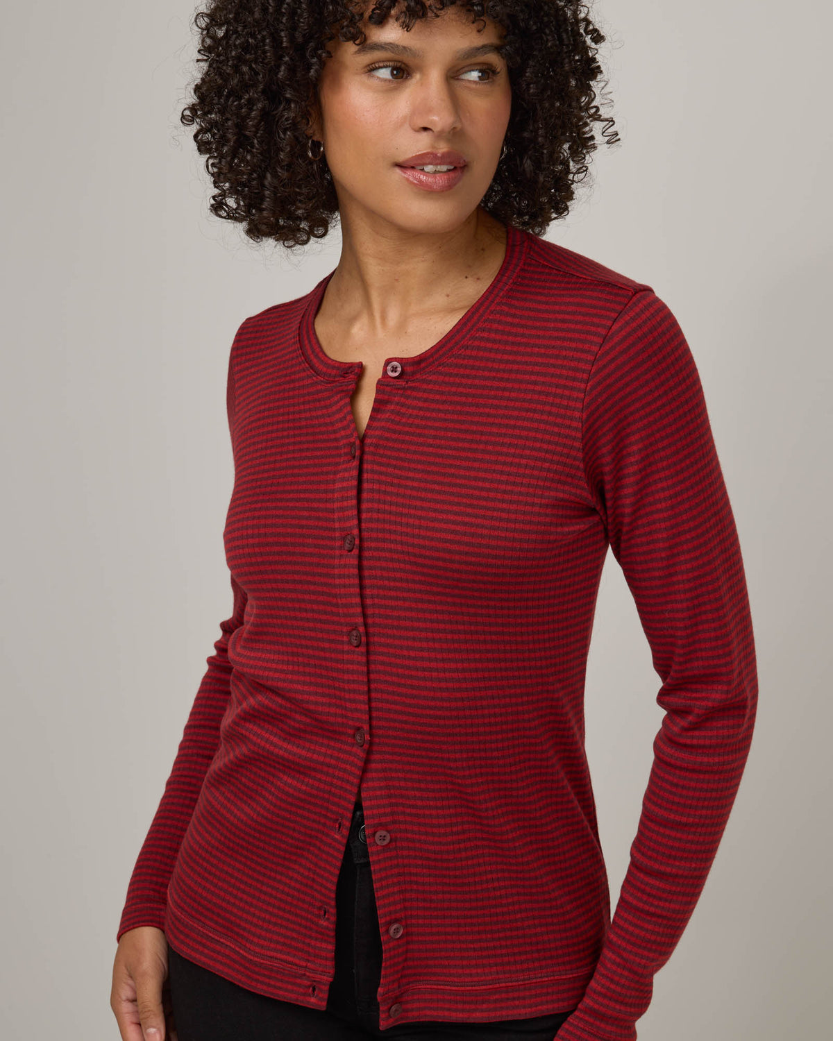 Model wearing Celeste Ribbed Cardigan in Burgundy & Modern Red Stripe. Celeste Ribbed Cardigan is a merino wool long sleeve, cardigan available in sizes XS-3X.