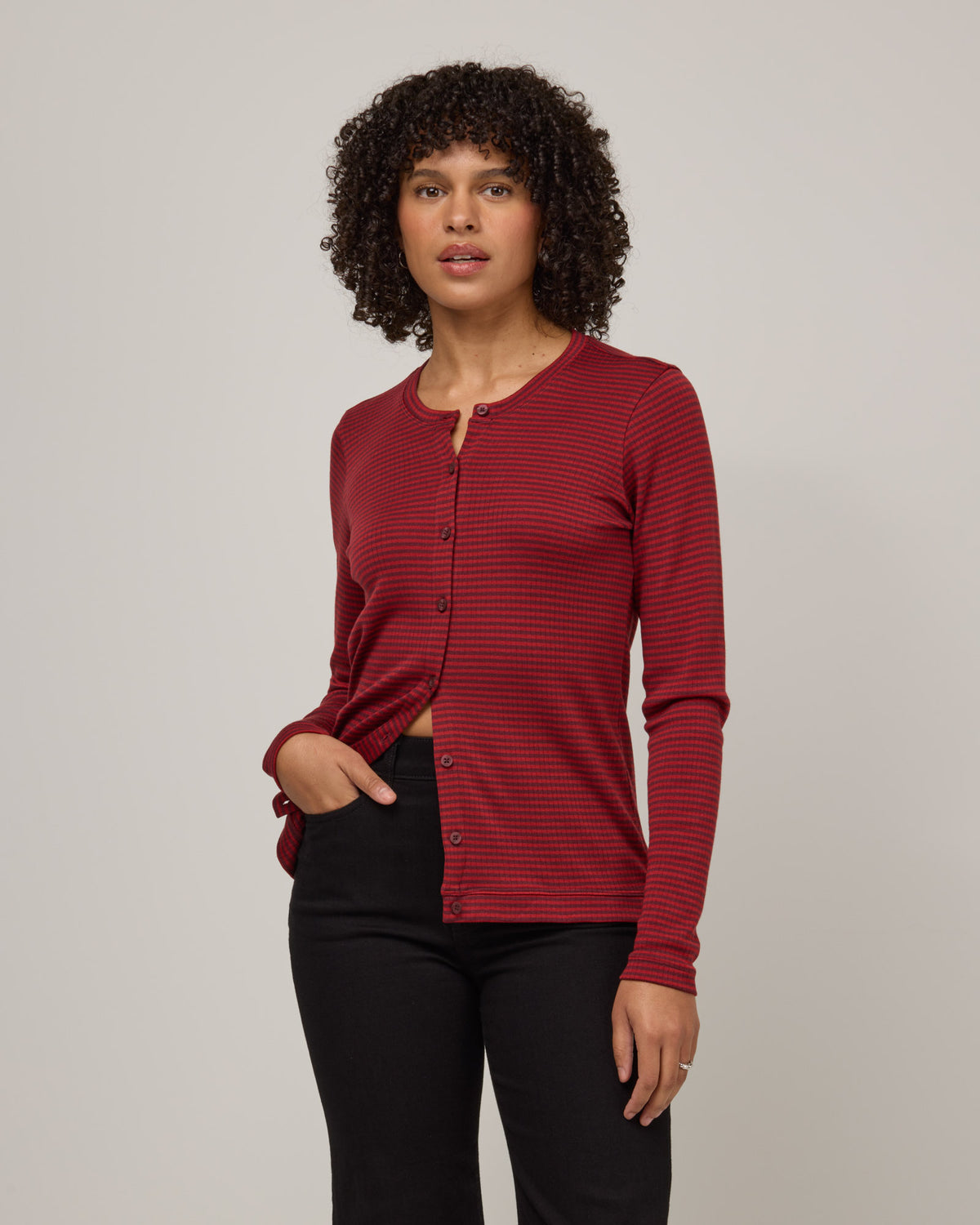 Model wearing Celeste Ribbed Cardigan in Burgundy & Modern Red Stripe. Celeste Ribbed Cardigan is a merino wool long sleeve, cardigan available in sizes XS-3X.