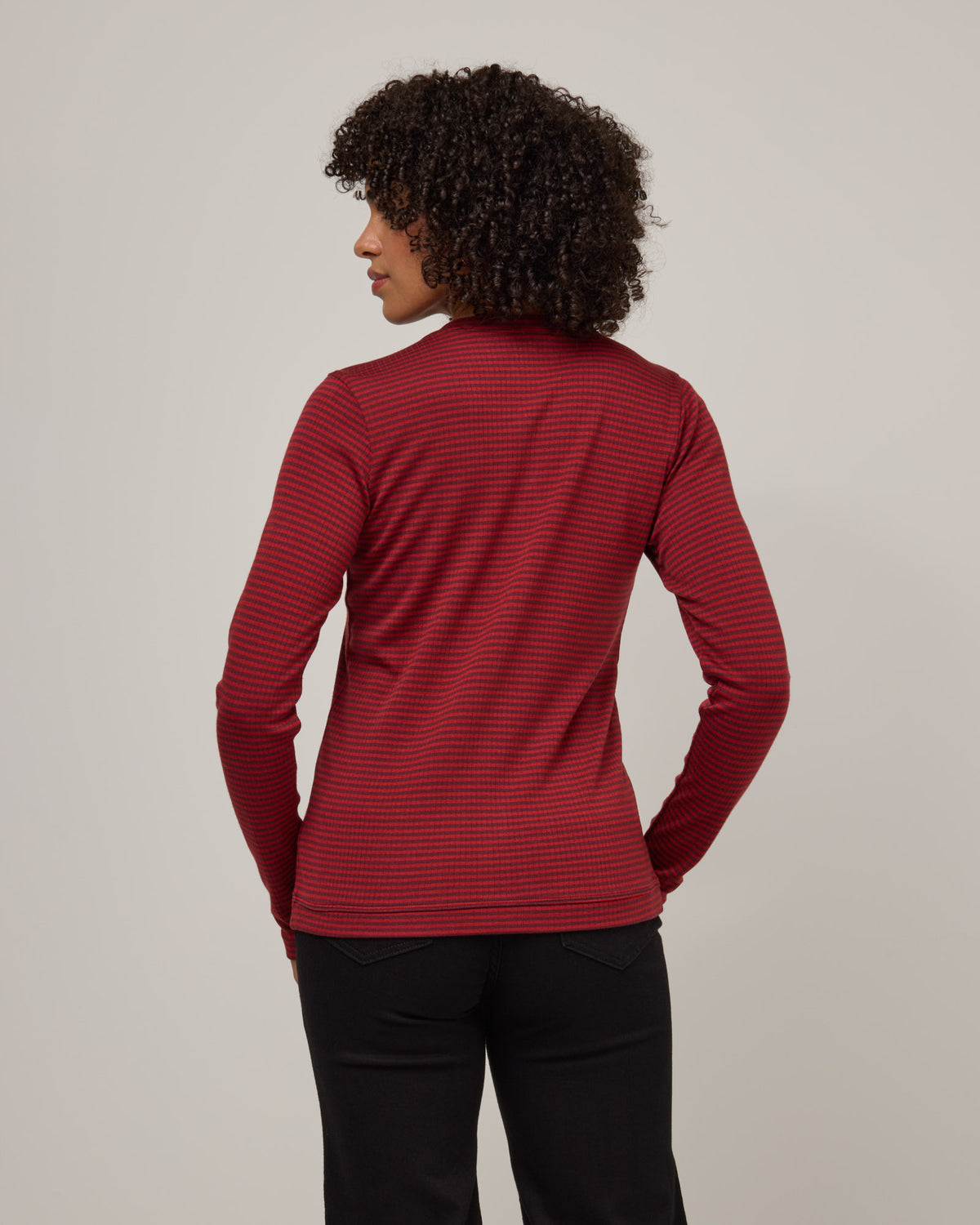 Model wearing Celeste Ribbed Cardigan in Burgundy & Modern Red Stripe. Celeste Ribbed Cardigan is a merino wool long sleeve, cardigan available in sizes XS-3X.