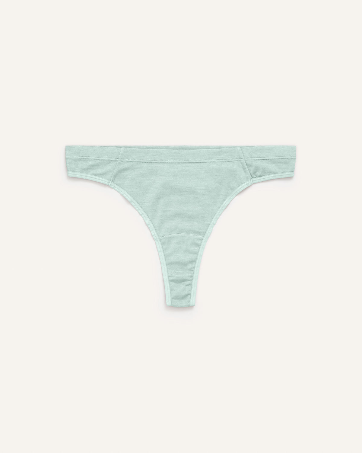 Laydown of Roam Thong in Morning Dew, a vivid mint green color. Roam Thong is a merino wool underwear available in sizes XS-3X.
