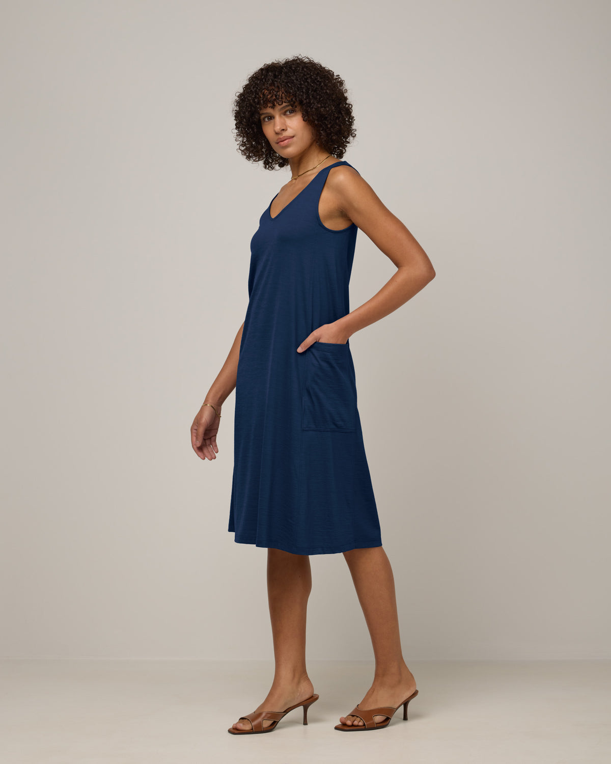 Model wearing Summer Reversible Dress in Marine Blue, a deep royal blue color. Summer Reversible Dress is a merino wool sleeveless, reversible, midi swing dress with pockets available in sizes XS-3X.