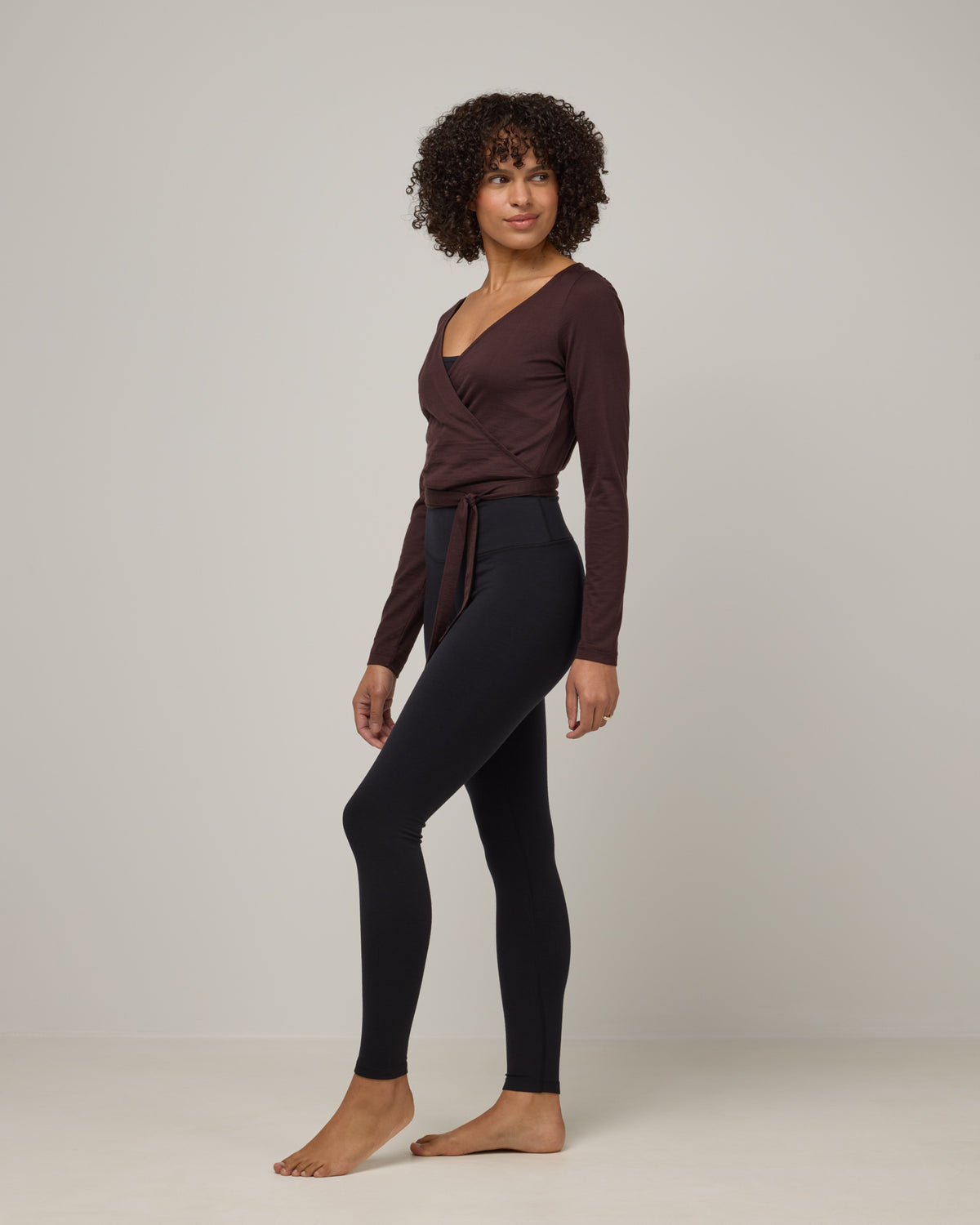 Model wearing Summit Legging in Black. Summit Legging is a merino wool legging available in sizes XS-3X Regular, S-XXL Long.