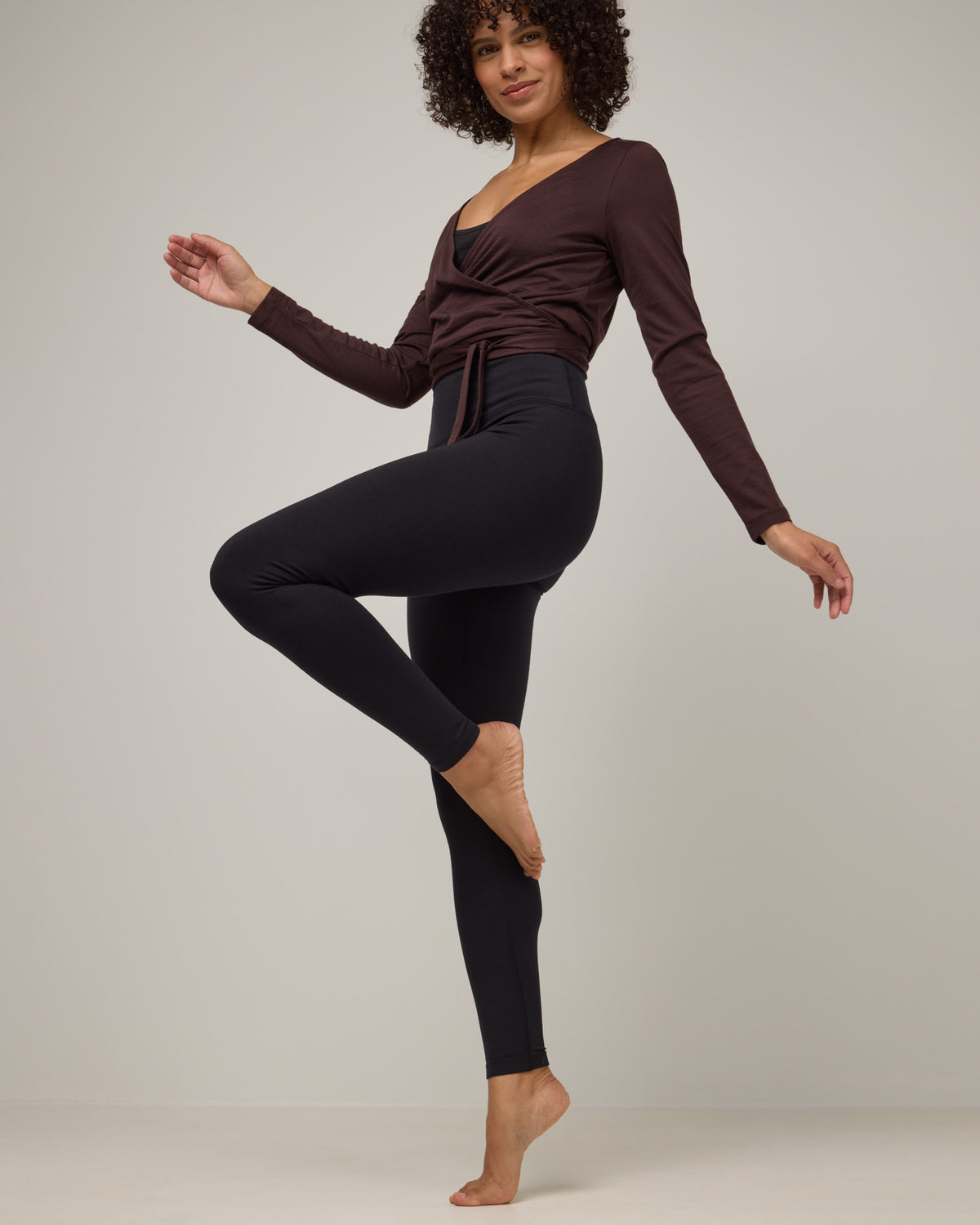 Model wearing Summit Legging in Black. Summit Legging is a merino wool legging available in sizes XS-3X Regular, S-XXL Long.